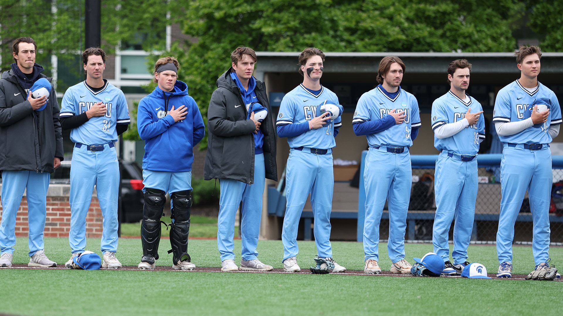 CWRU baseball players standing for the National Anthem