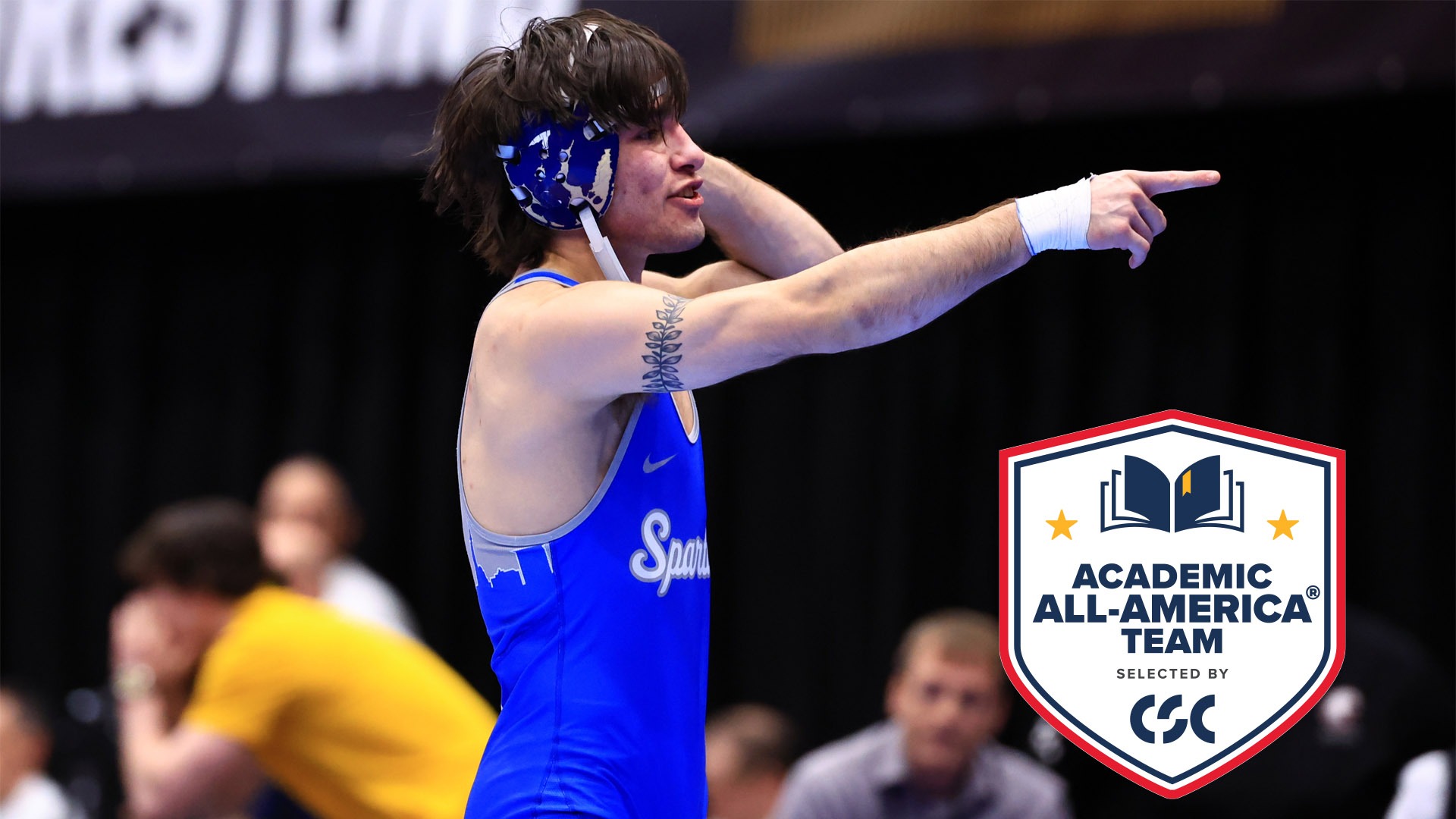 Art Martinez pointing to the crowd at the national championship with the CSC Academic All-America logo bottom right