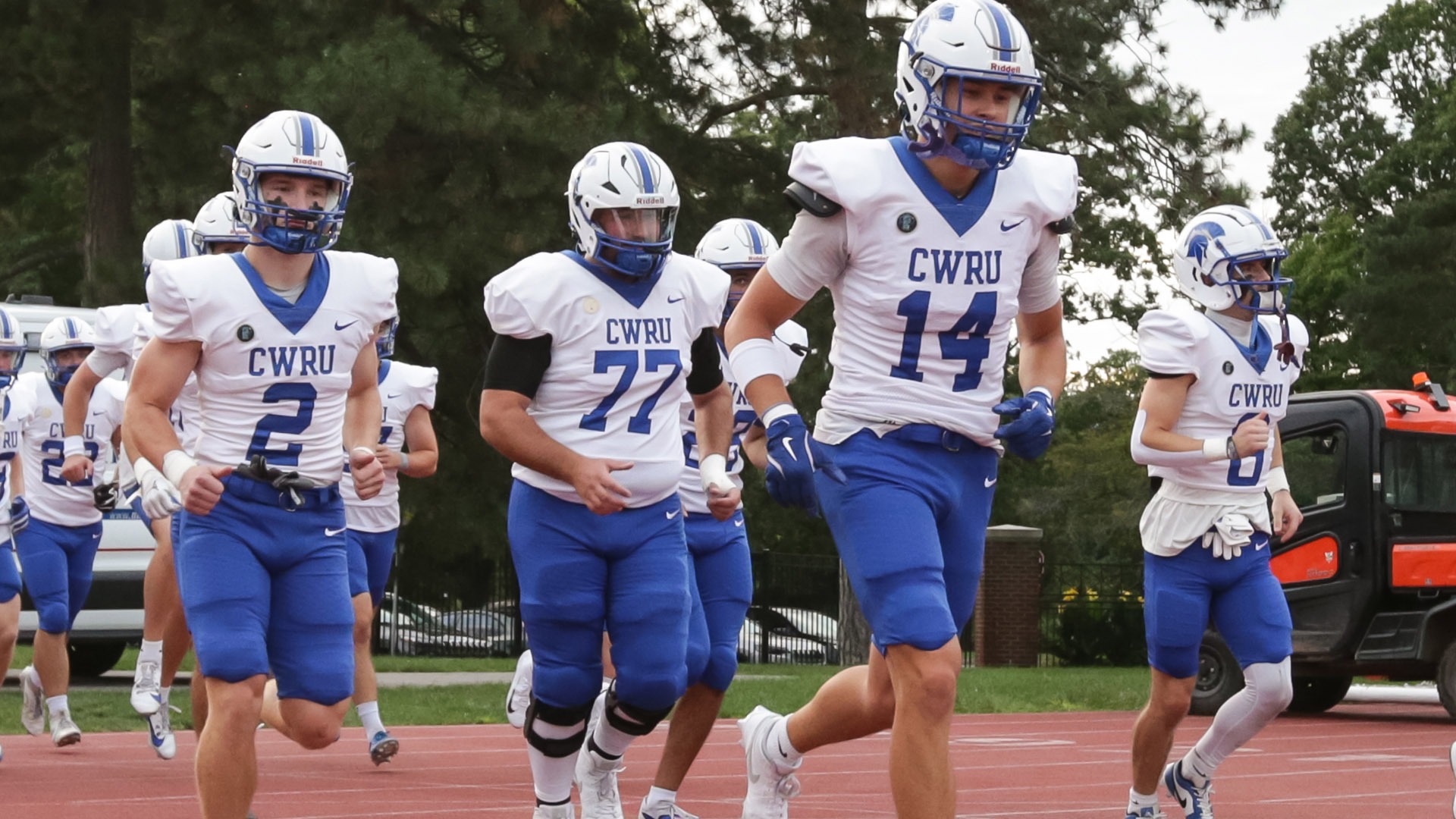 CWRU players running onto the field before the game against Rochester