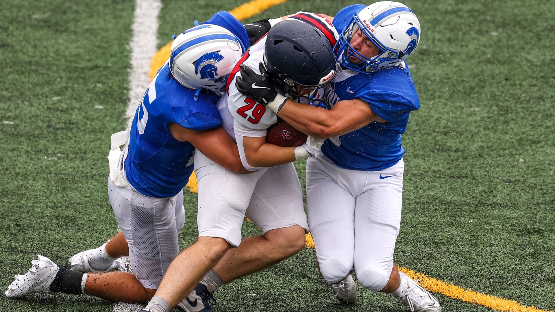 Two Spartan defenders making a tackle against Shenandoah