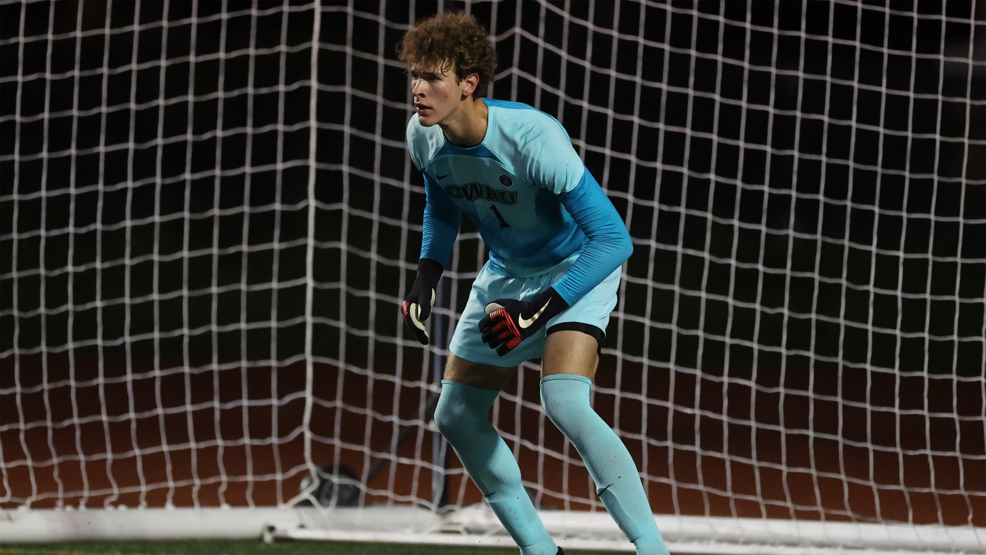 Carter Shedd standing in front of the net against OWU