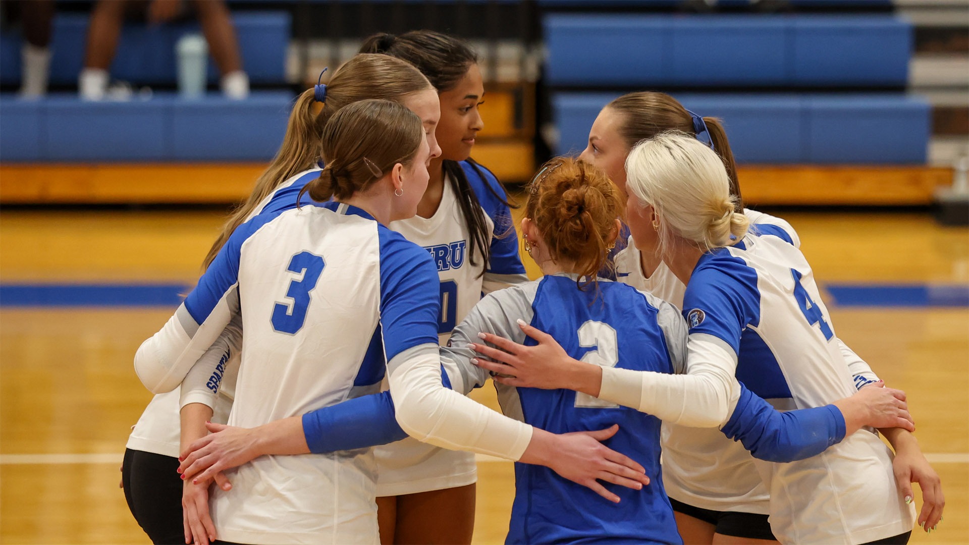 Members of the Case Western Reserve University volleyball team in a huddle
