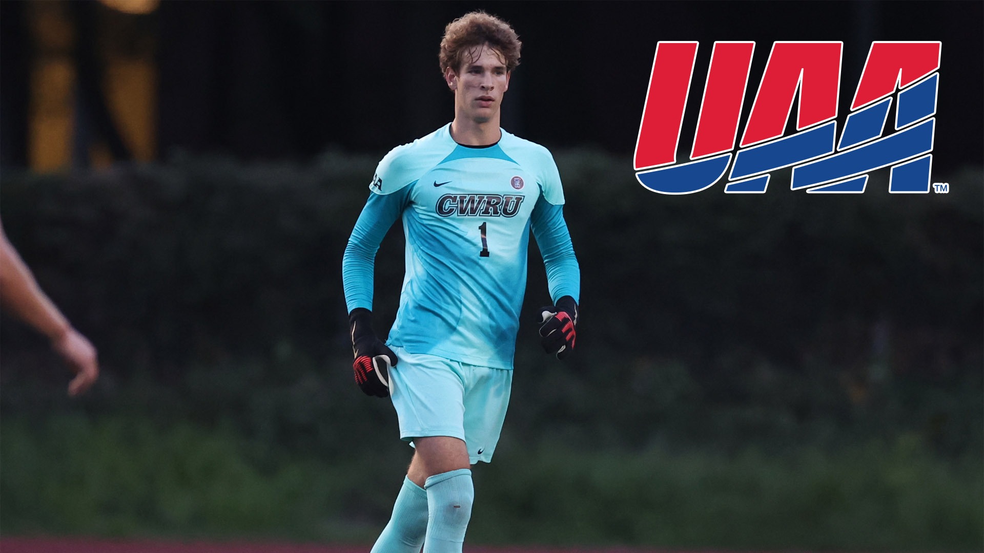 Carter Shedd standing with the UAA logo in the top right corner