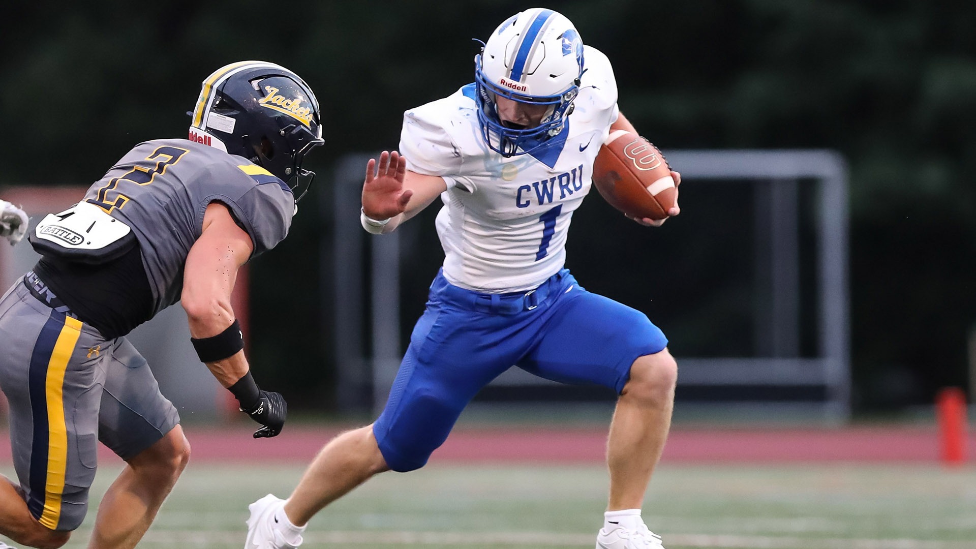Andy Kavcic stiff arms a Rochester defender