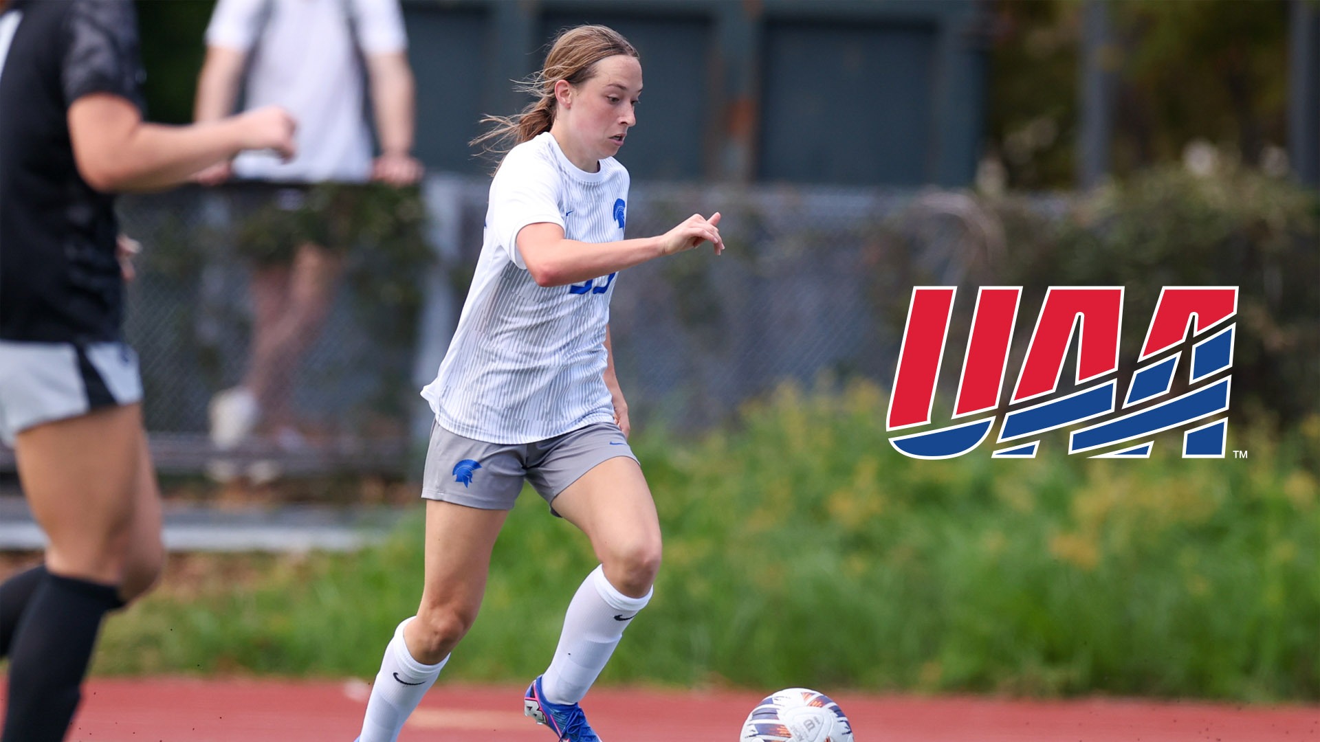 Izzy Probst on the attack against Capital with the UAA logo on the right