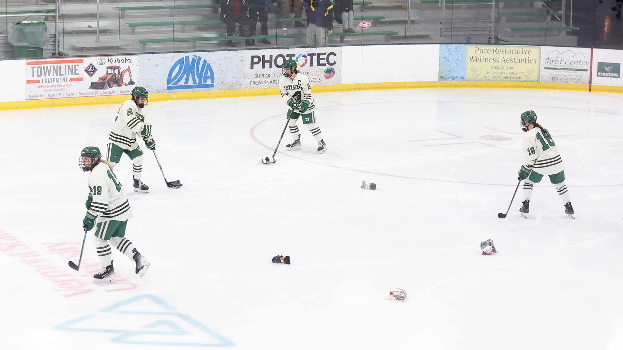 The Spartan hockey team collects socks during the team's annual Sock Toss contest