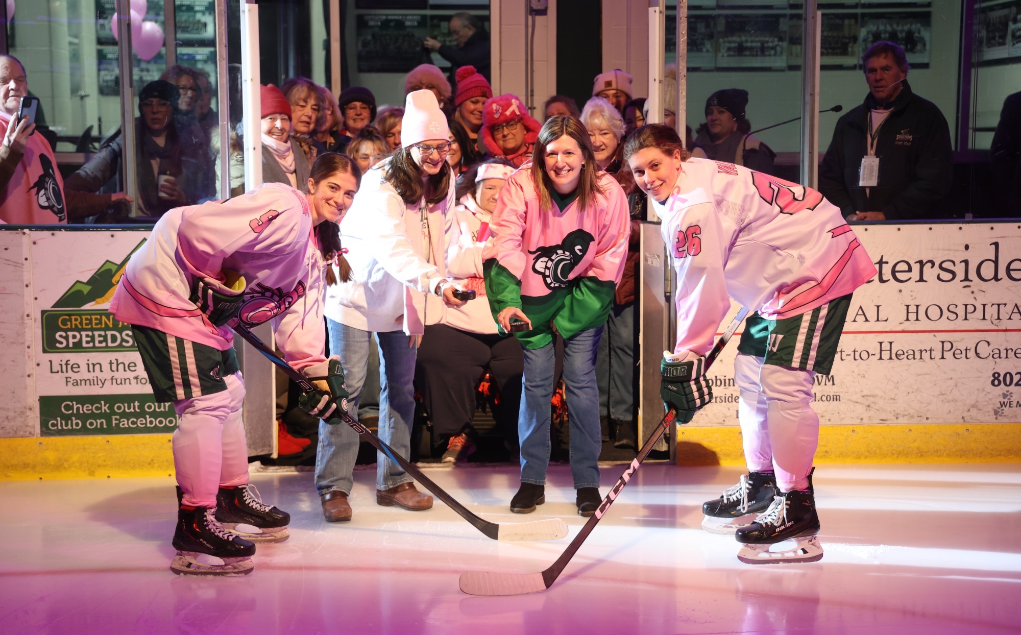 Megan Culp and Amanda Vaughn pose for Pink the Rink puck drop with their mothers