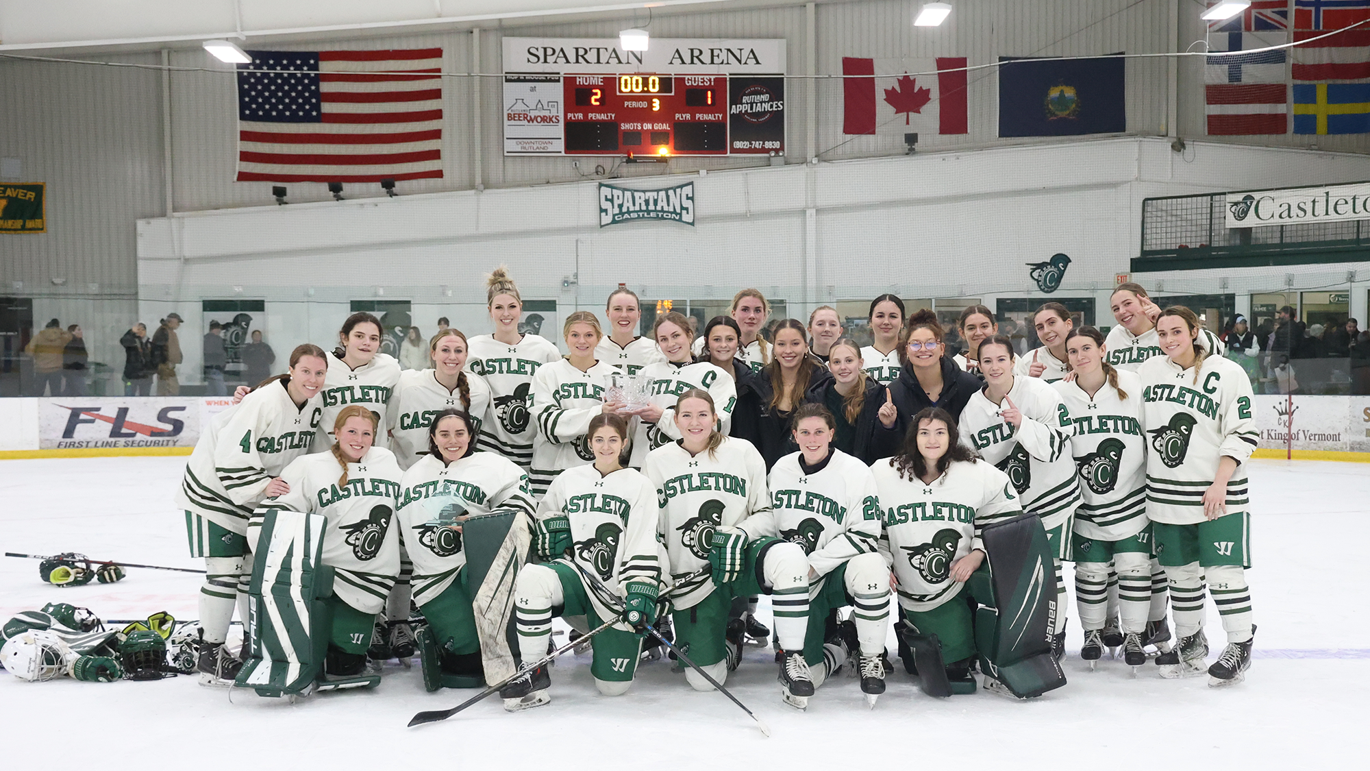 The 2025-26 Castleton women's ice hockey team posses with the Bagley Invitational Cup after defeating Worcester State 2-1