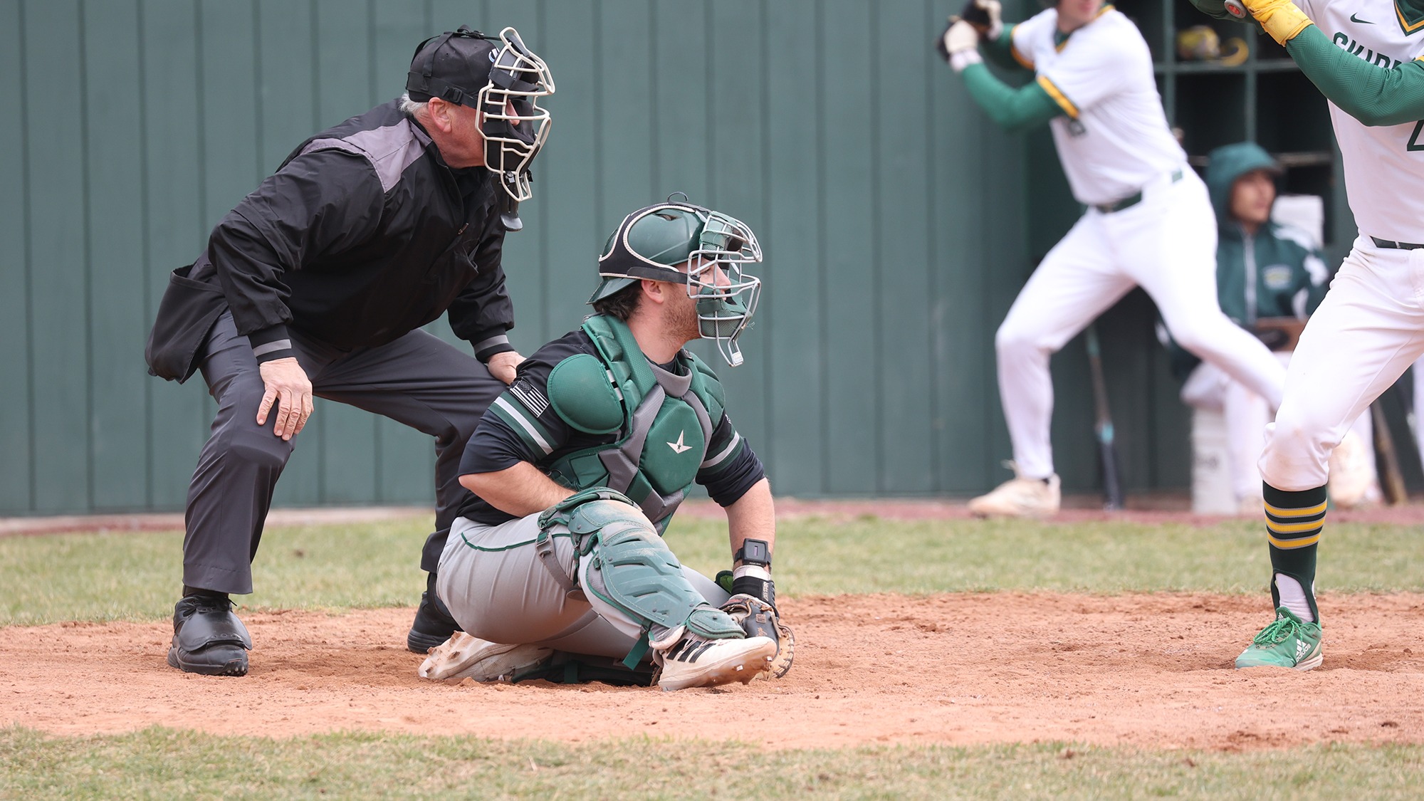 Trey LaVigne catches in front of the umpire behind home plate