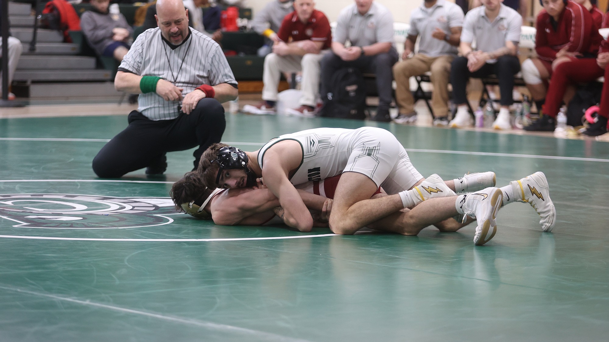 Drew Marchese wrestling on top of opponent with ref in the background