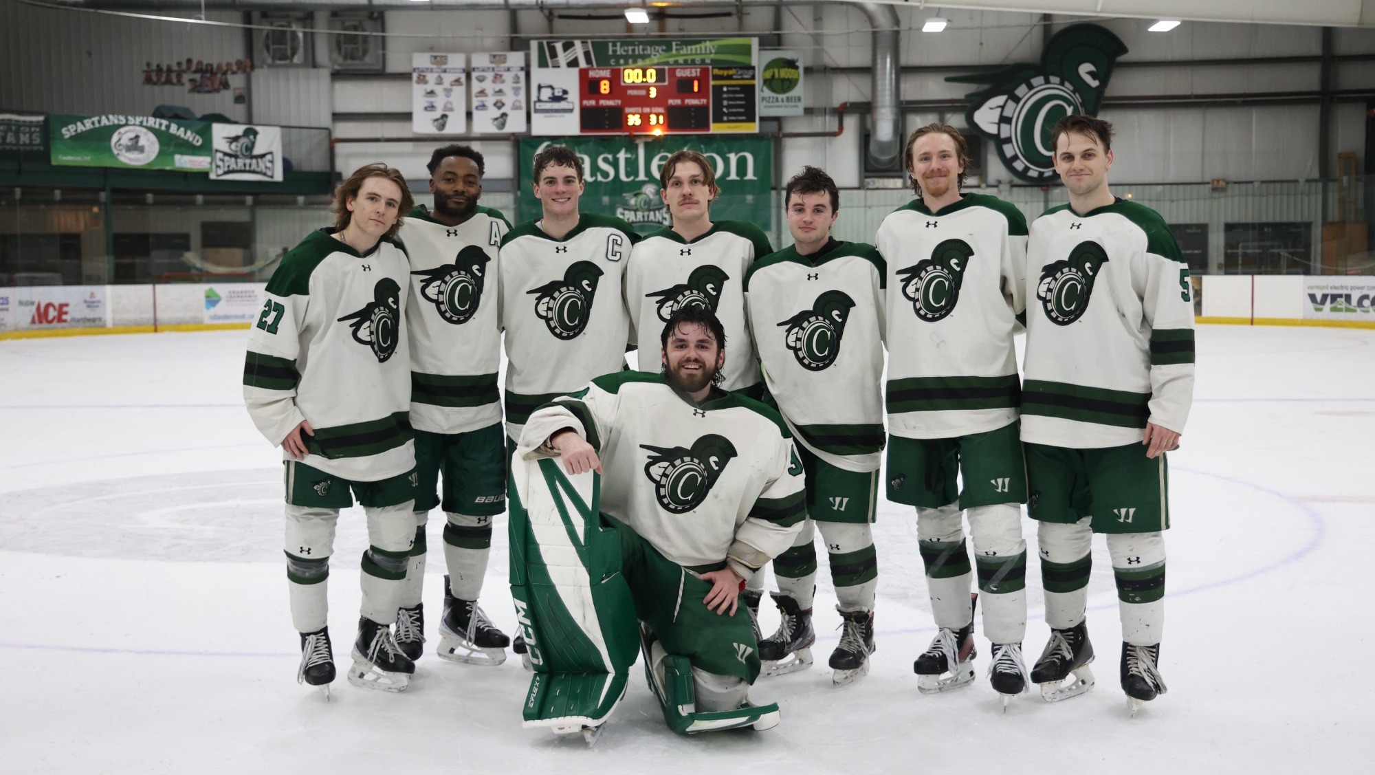 Men's Hockey class of 2026 poses at center ice