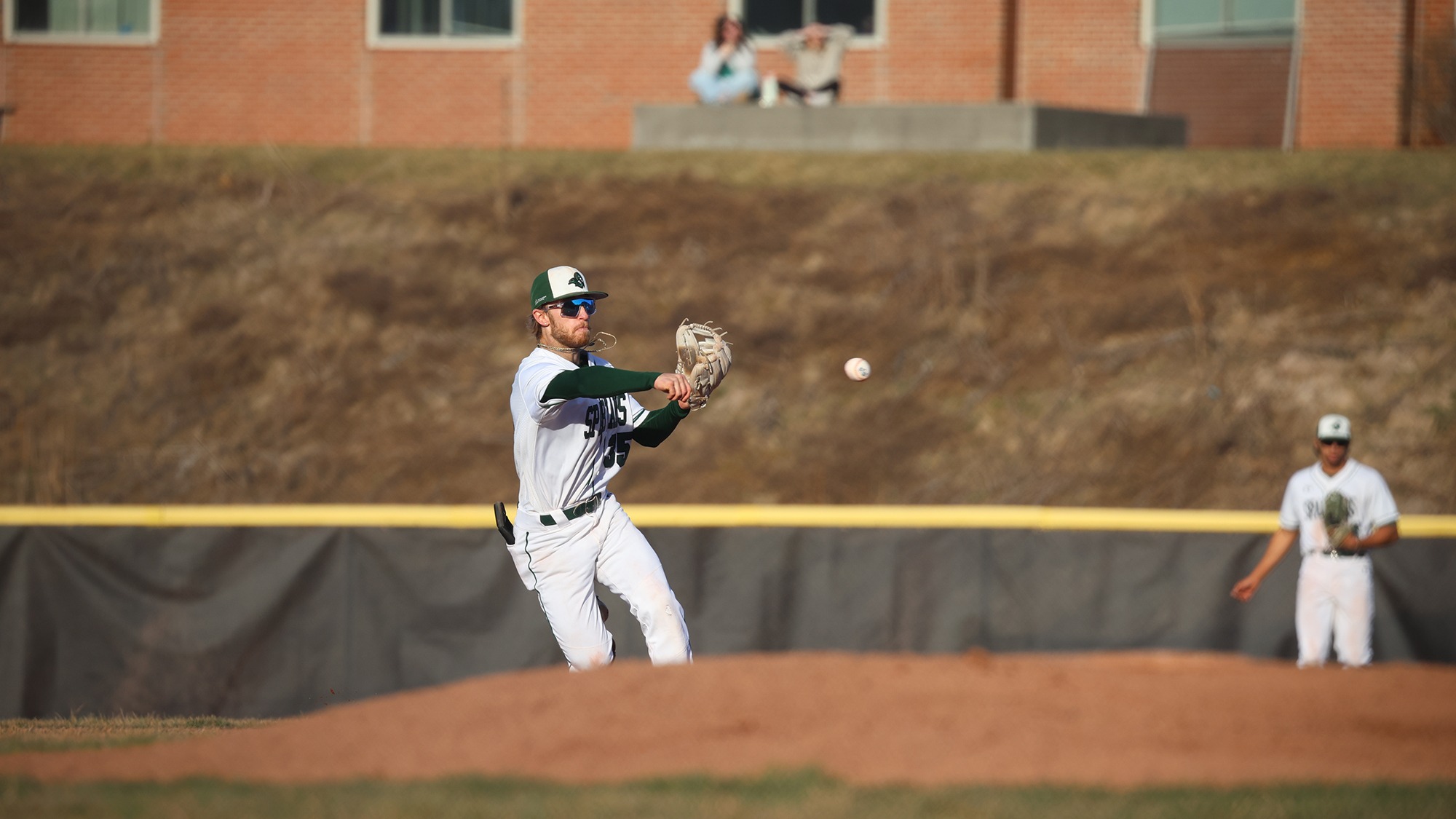 Mikey Raby Jr. throwing a ball in the field