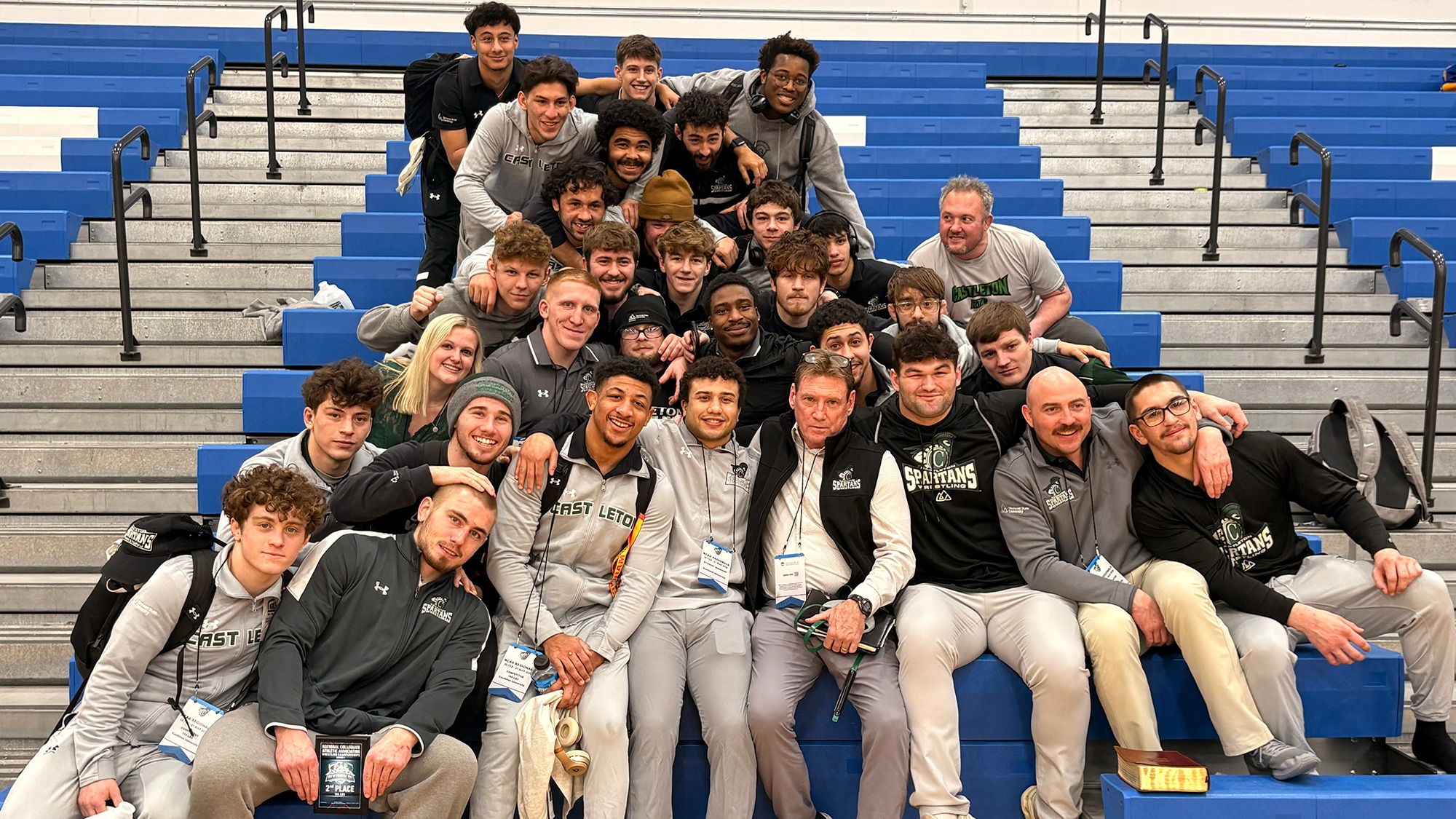 Wrestling Team after NCAA Regionals posing on bleachers