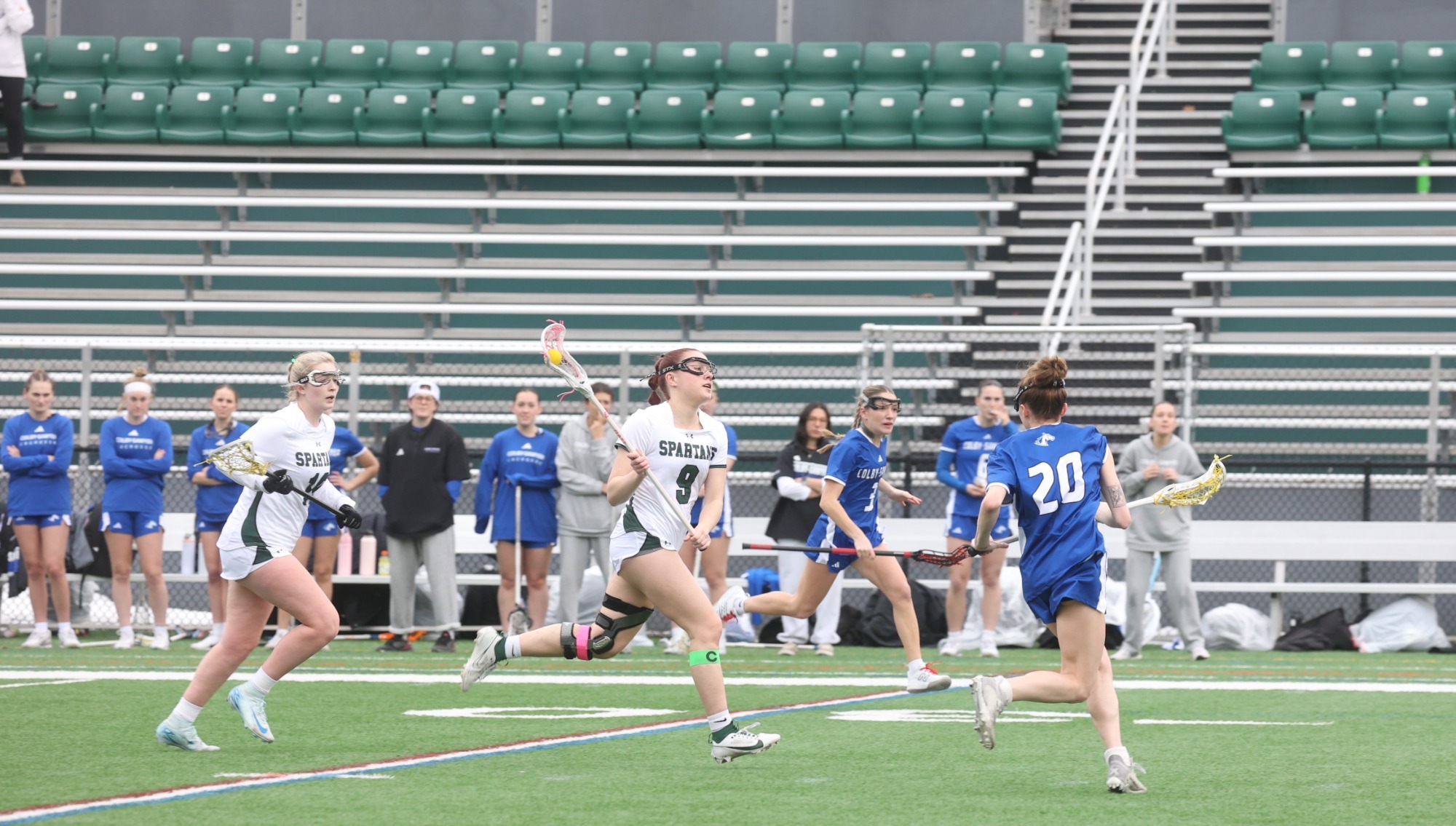 Renny Cota (with the ball) and Taylor Taldmadge running up the field against Colby-Sawyer