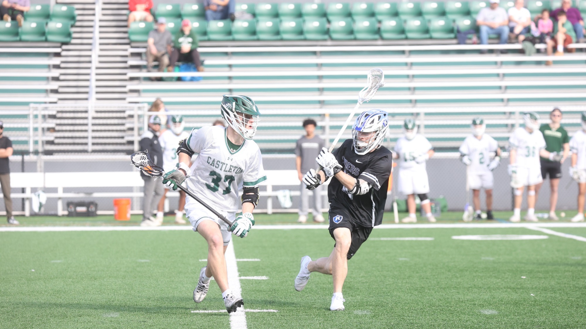 Jason Samek carries ball up field with pressure from defender