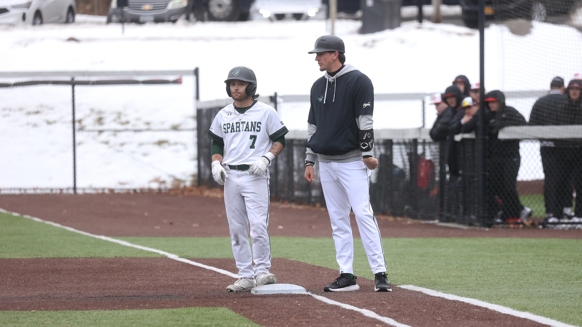 Joe Castellano and Coach McDonough talking at first base