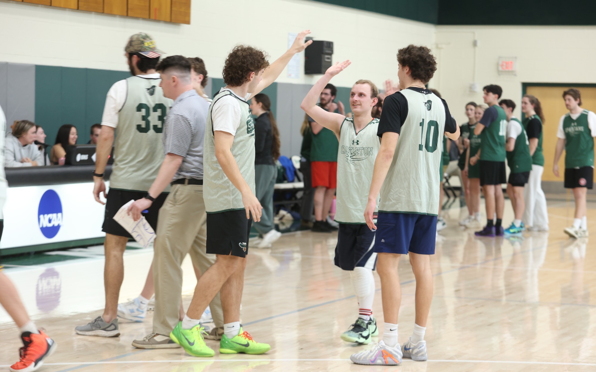 Jake Oglesby high fives Peter Maass during a timeout at the 2026 Unified Game