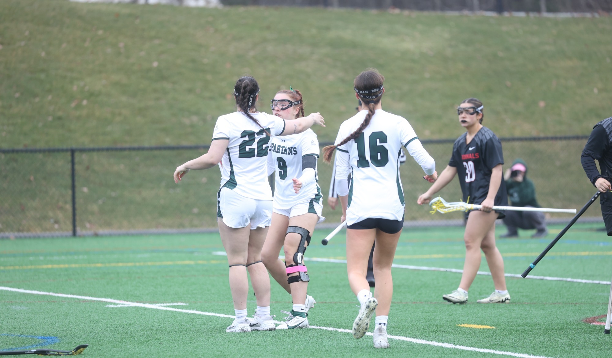 Renny Cota and Bella Gale hug to celebrate goal. Lanza Bellomo in foreground