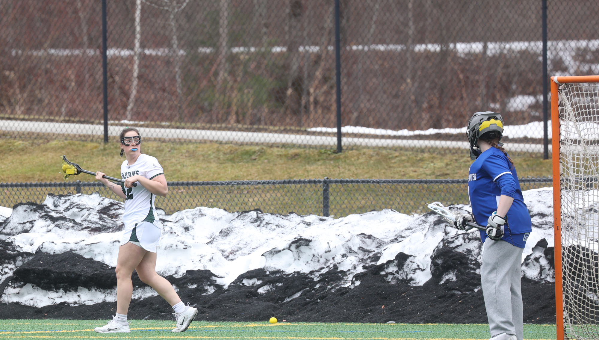 Bella Gale looks back at opponent's goalie suspiciously 
