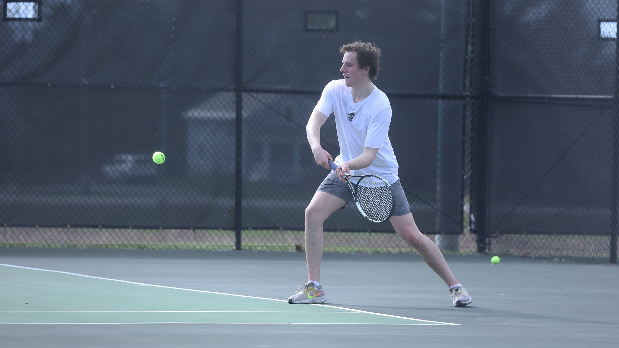 Tyler Burke returning a shot