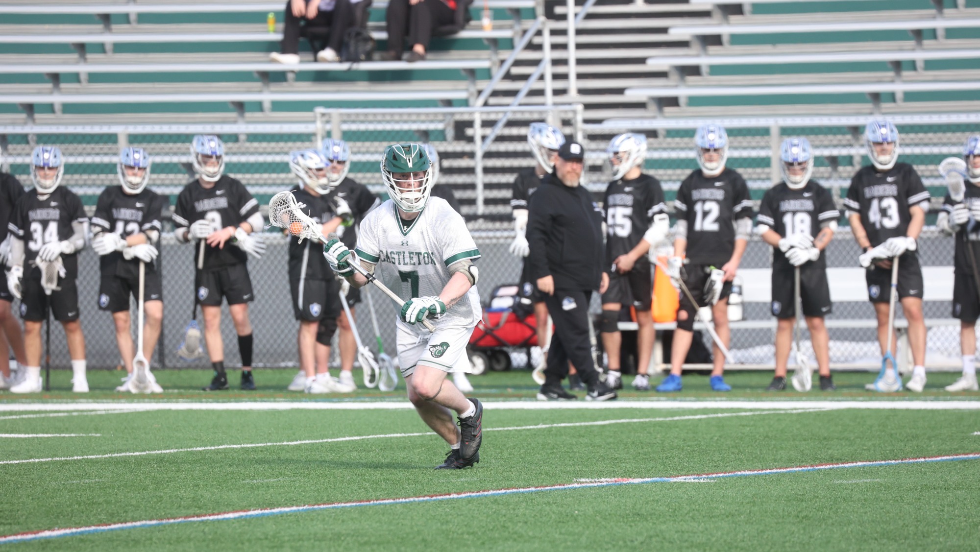 Carter Frankenhoff with ball (opposing team bench in background)