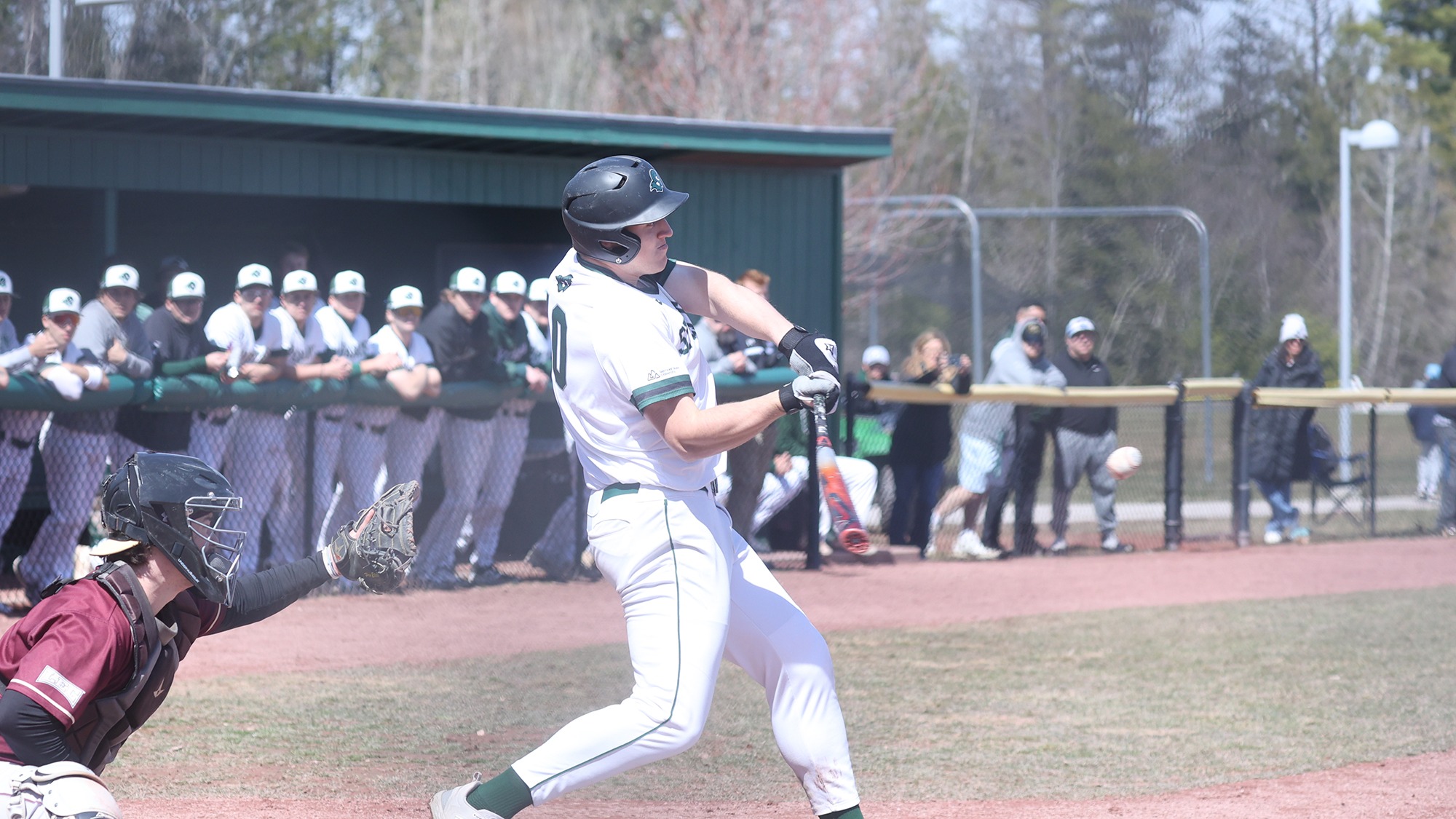 Justin Strozyk hitting the ball against Rhode Island College