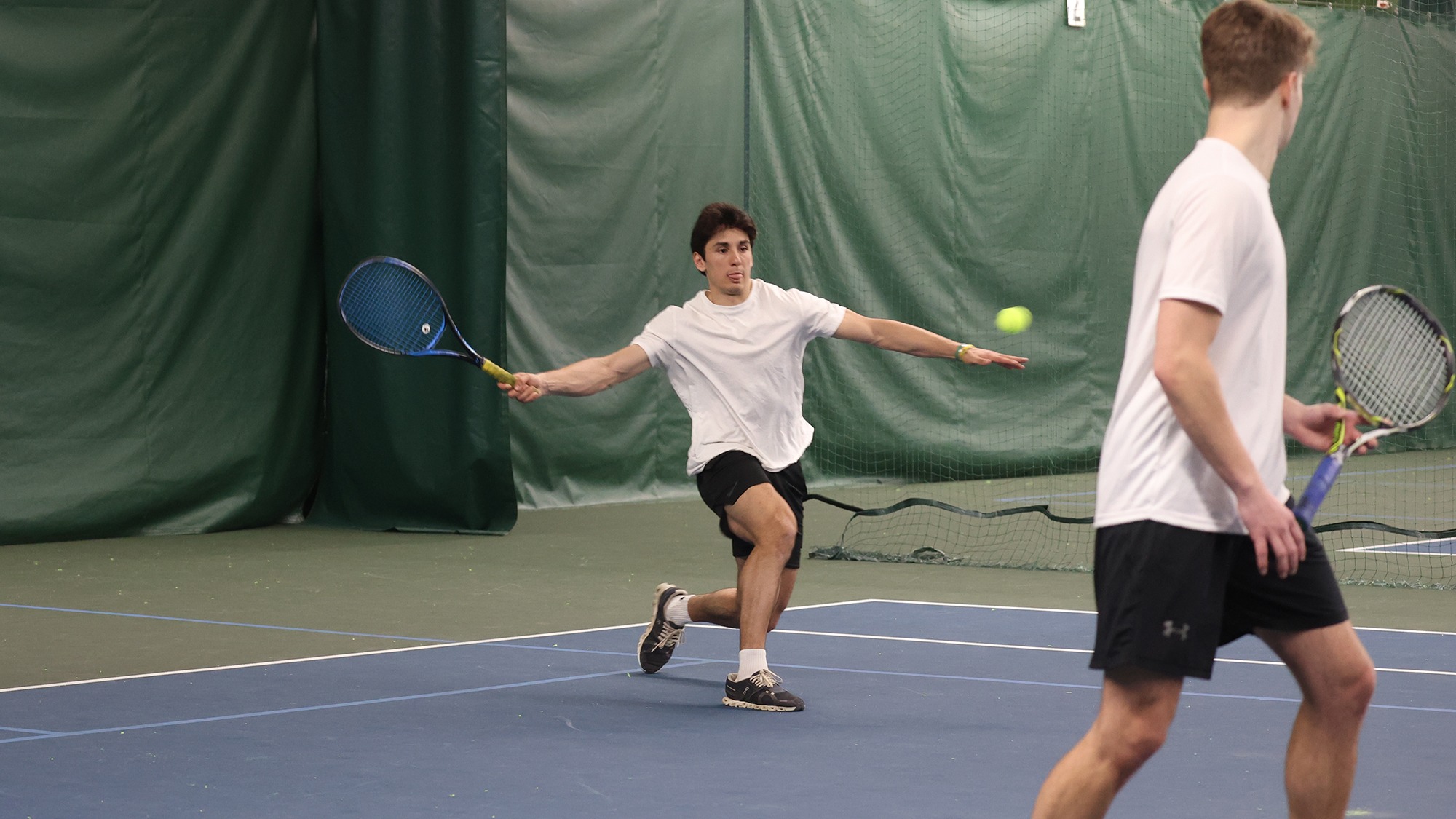 Trevor Castino hitting the ball back during doubles