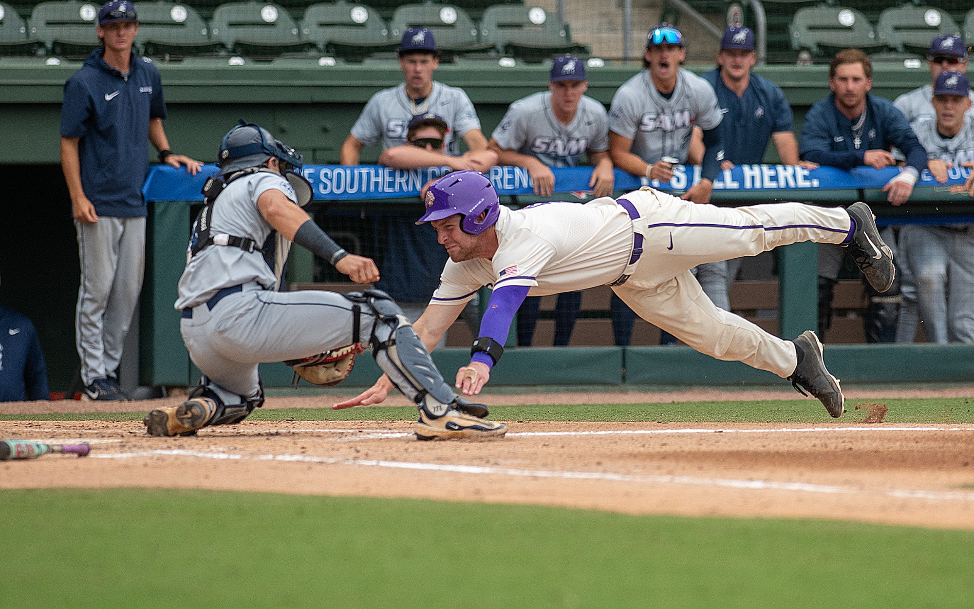 Senior Cam Murray dives for home but was put out at the plate, keeping the Catamounts behind a run early in Friday's Southern Conference semifinal at Fluor Field.
