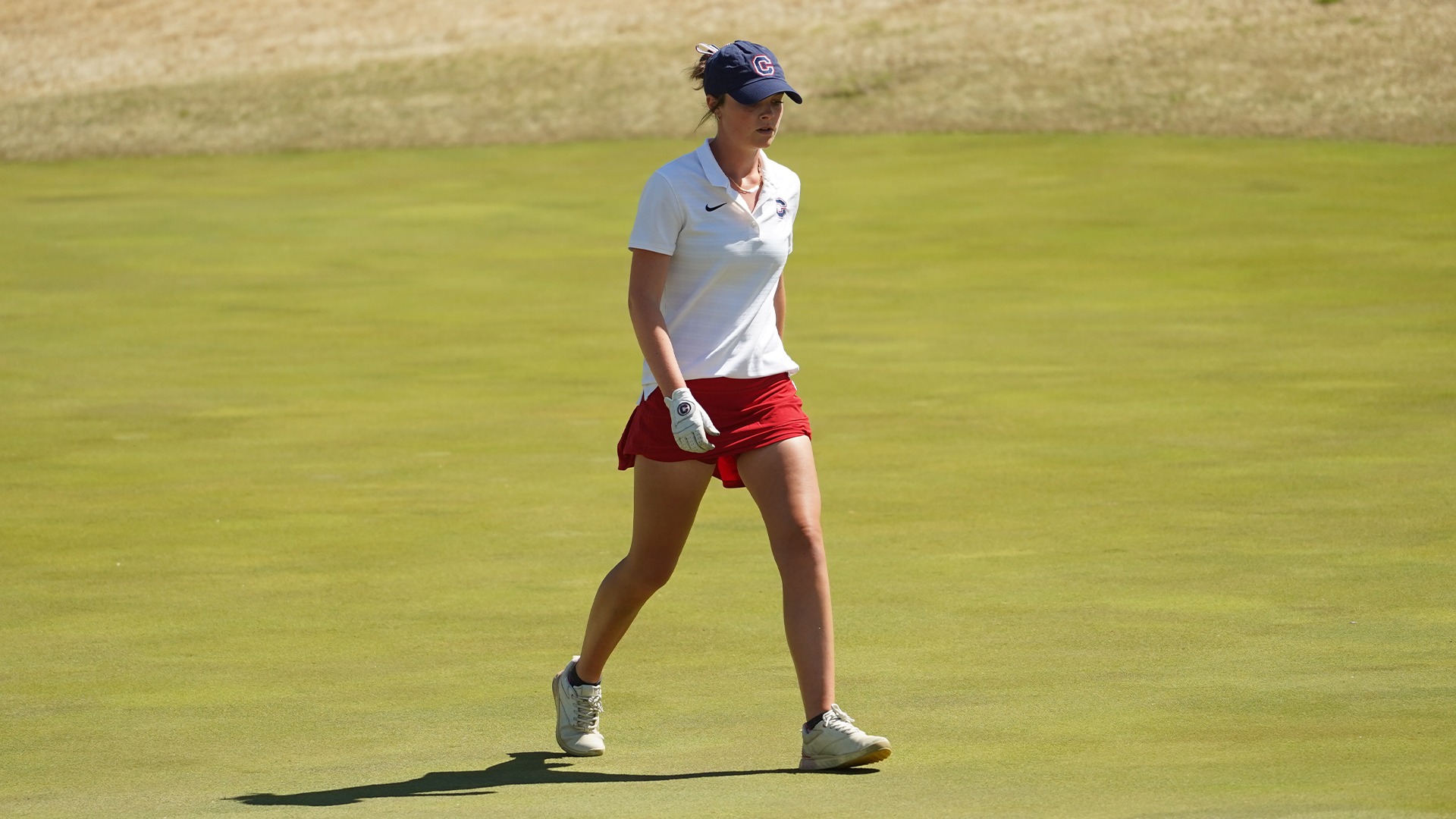 Mary-Paige King walks across the green