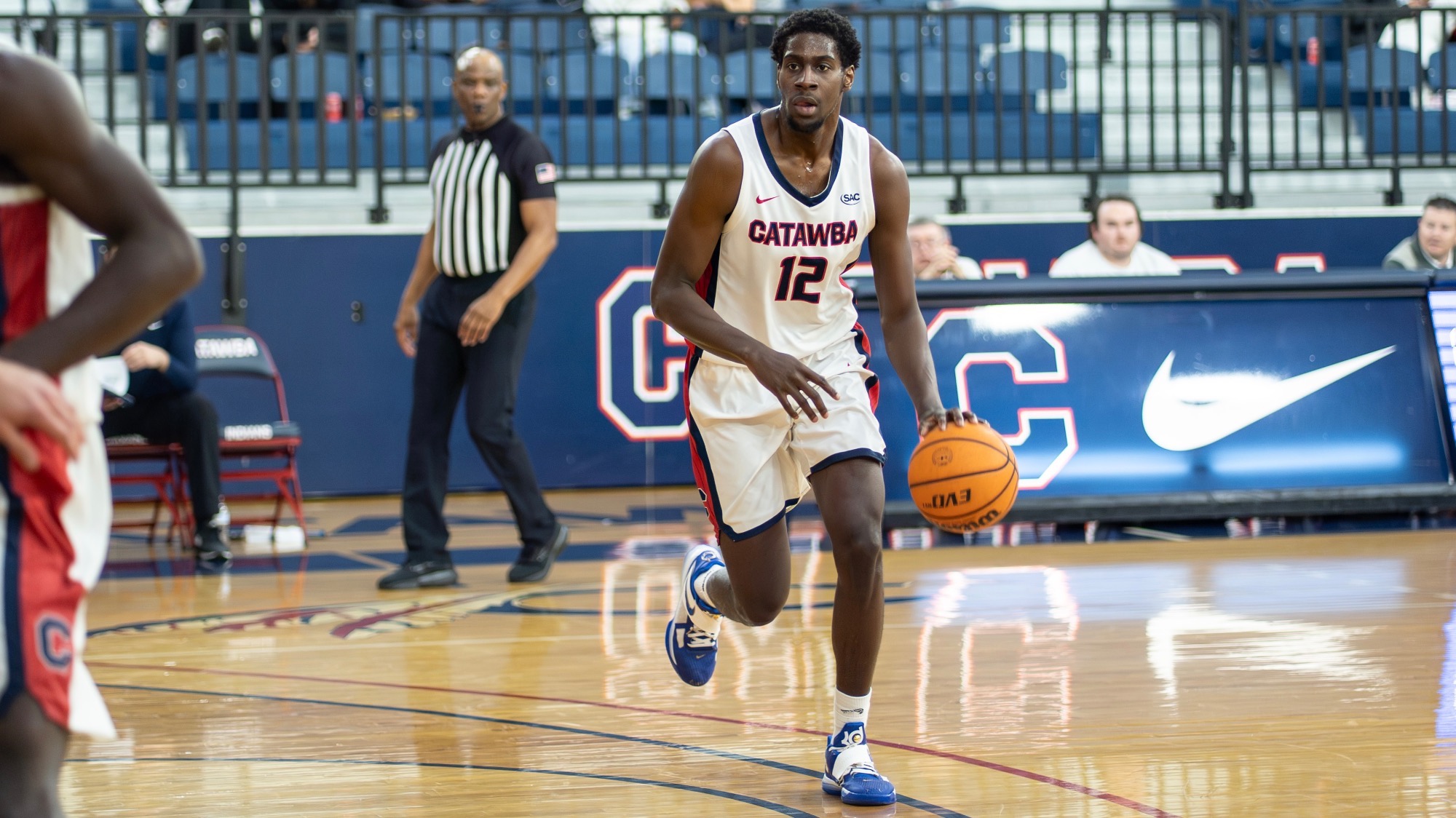 Justin Banks dribbling on the perimeter against Coker