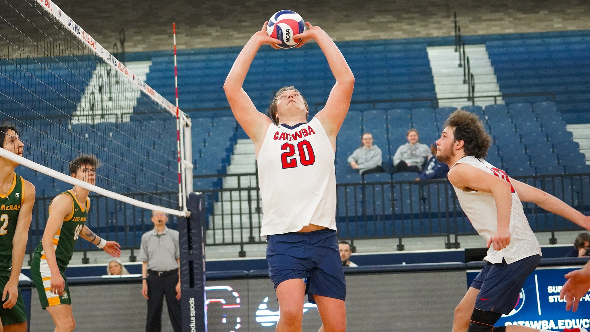 Kristian Smith setting as Wyatt Eastin prepares to leap against Lees-McRae