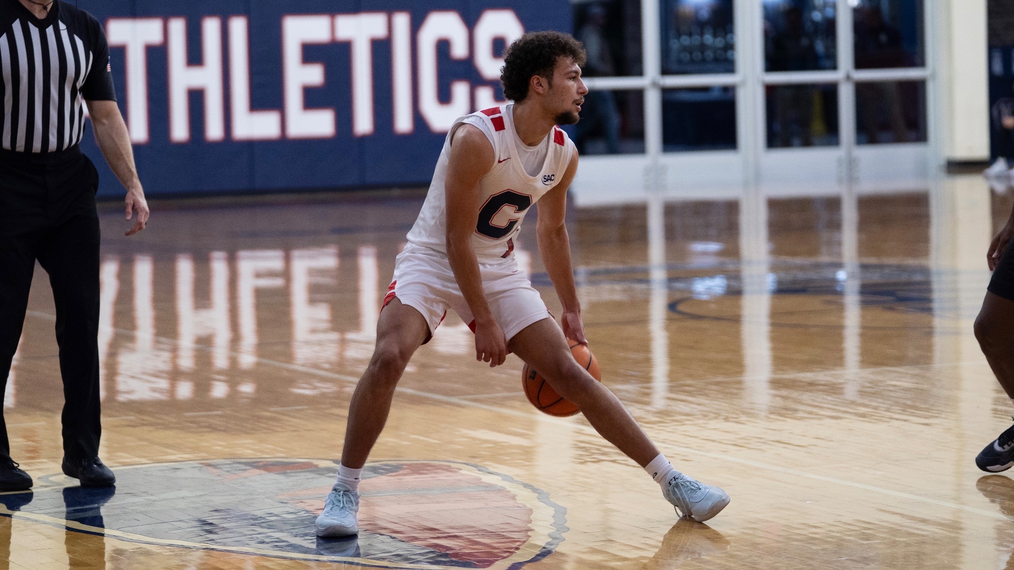 Carson Daniel dribbles against Lenoir-Rhyne