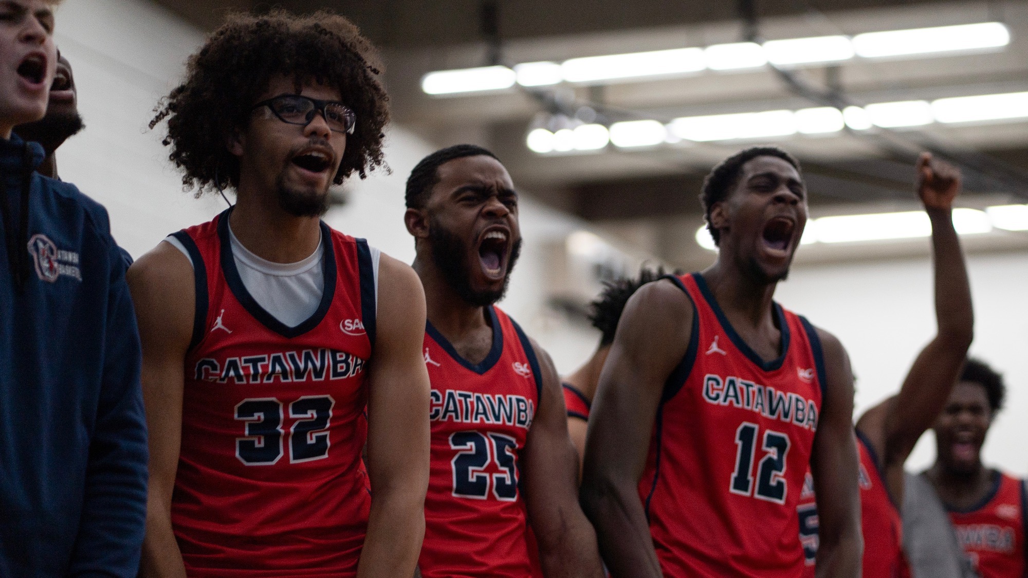 Men’s Basketball bench celebrating a big play against Livingstone
