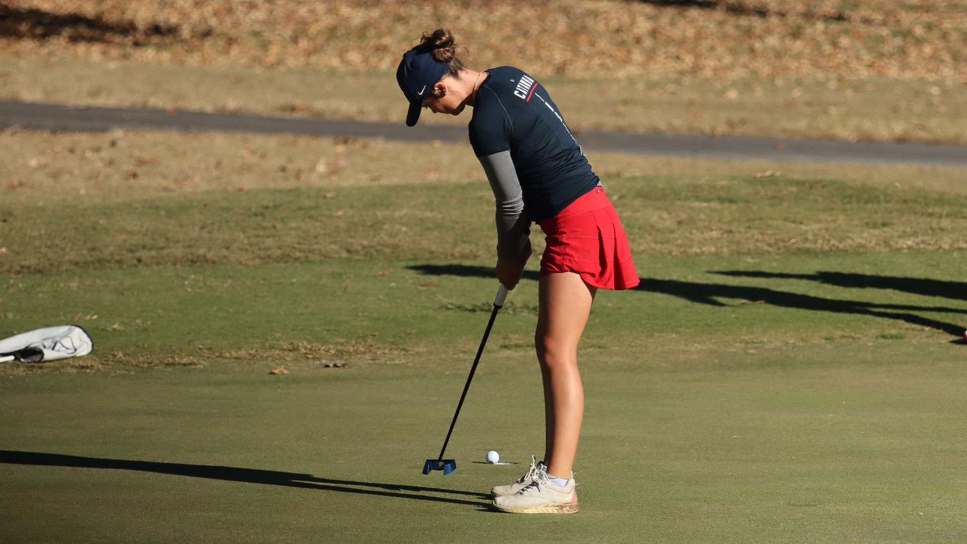 Mary-Paige King watches her putt go in at the UNCG Collegiate