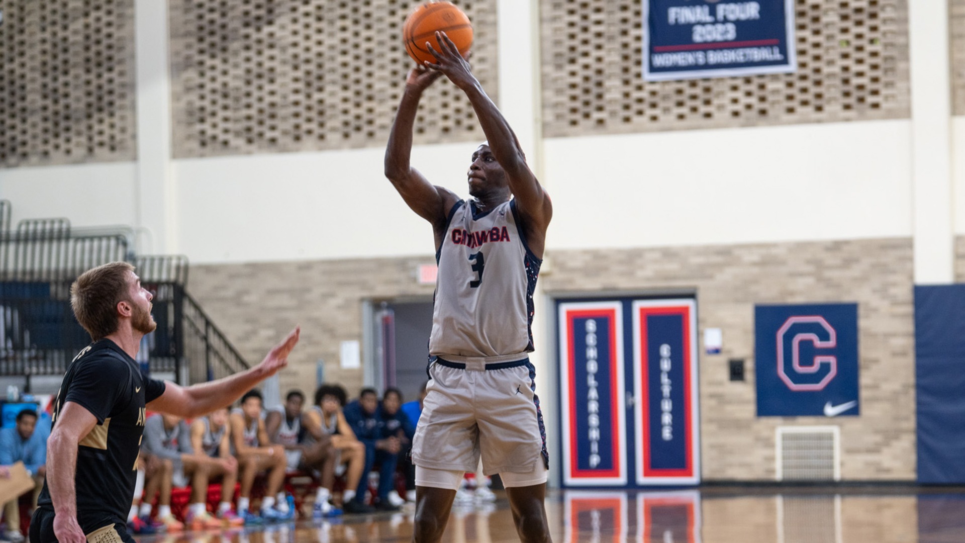 Ibra Athie shooting a jump shot against Anderson