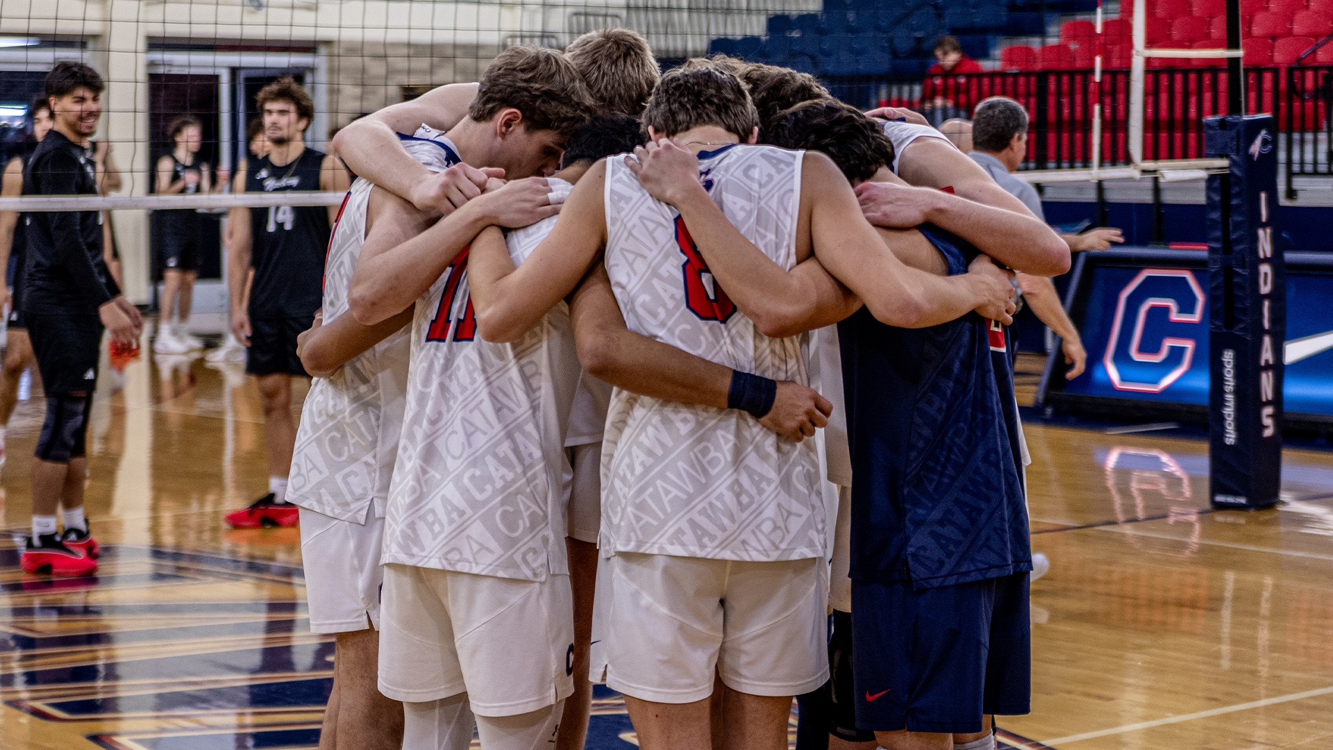 Men's Volleyball huddling against Newberry