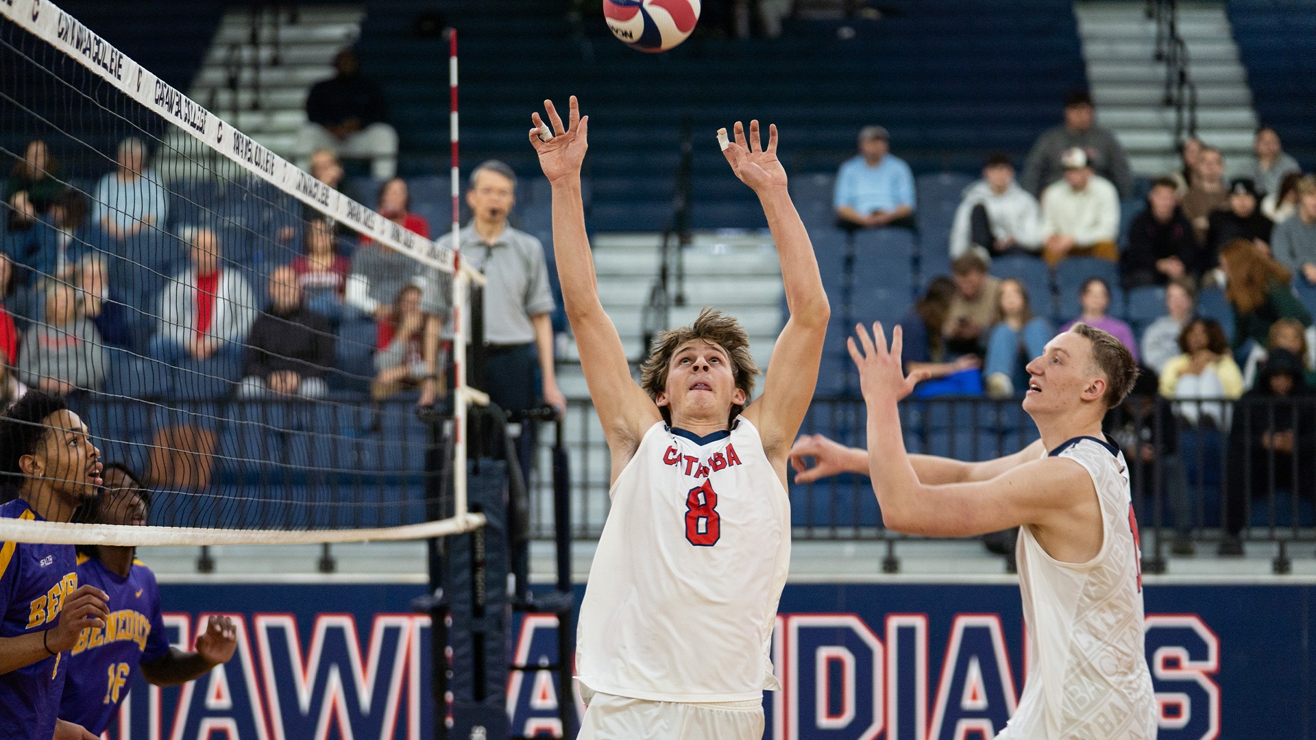 Mason Archer setting a ball for Logan Neitzel against Benedict