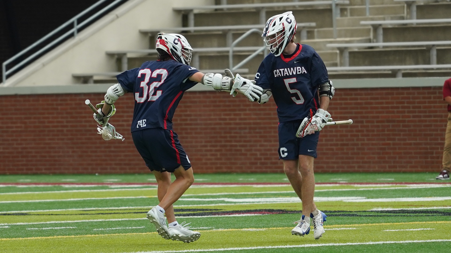 Garrett Simi and Michael Lindsey celebrating a goal against Lenoir-Rhyne
