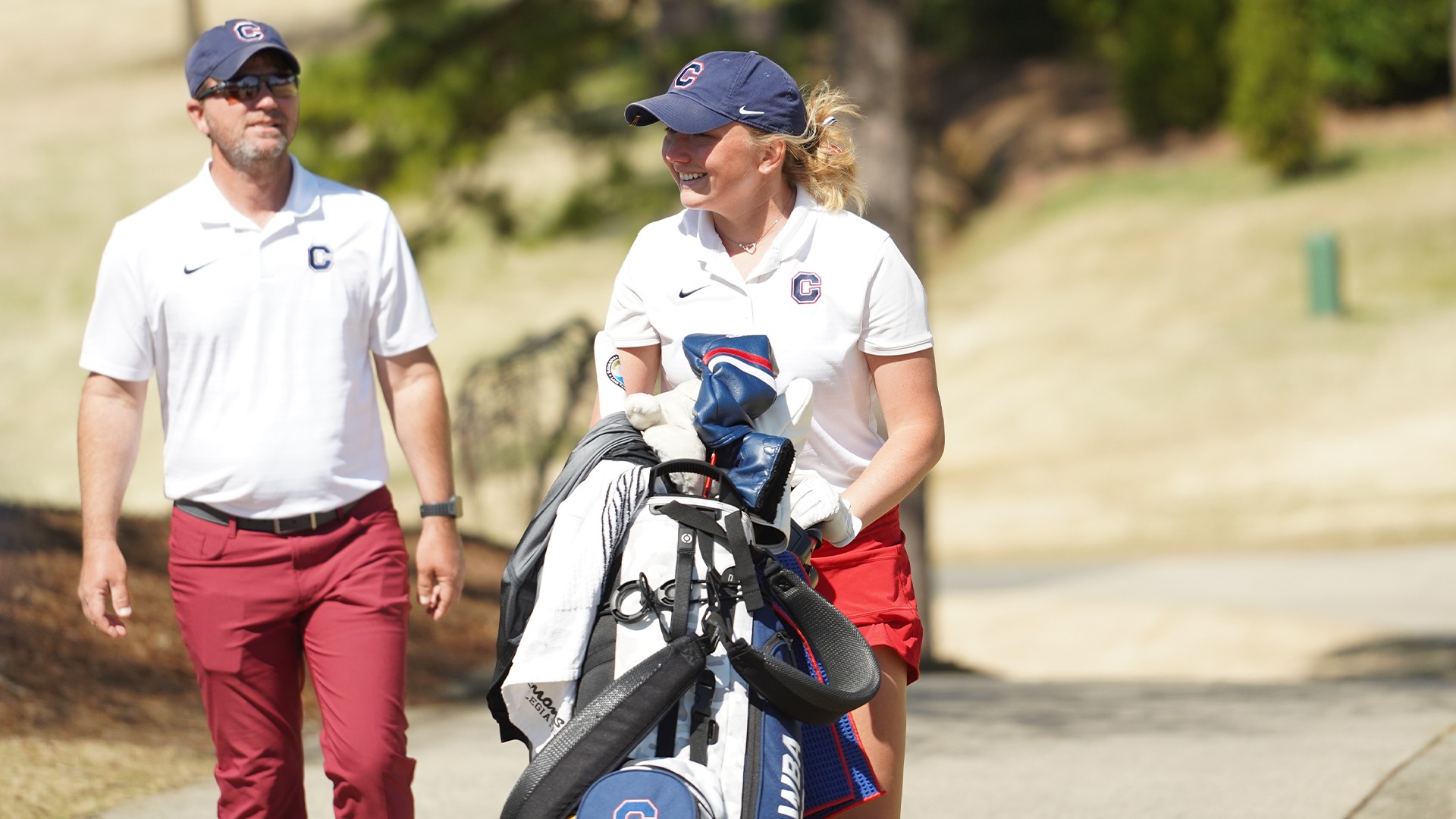 Rachel Carlson pushes her golf bag uphill at the Country Club of Salisbury