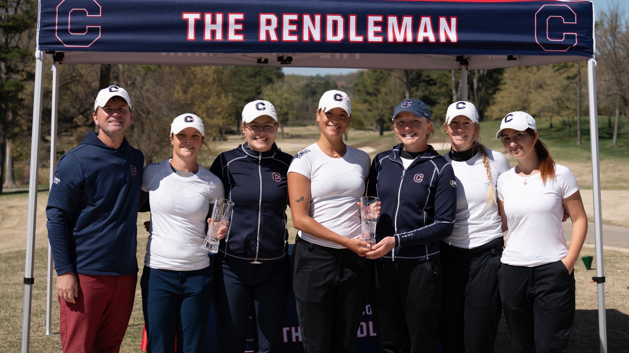 Women’s Golf team posing with trophy after winning the Patsy Rendleman Invitational