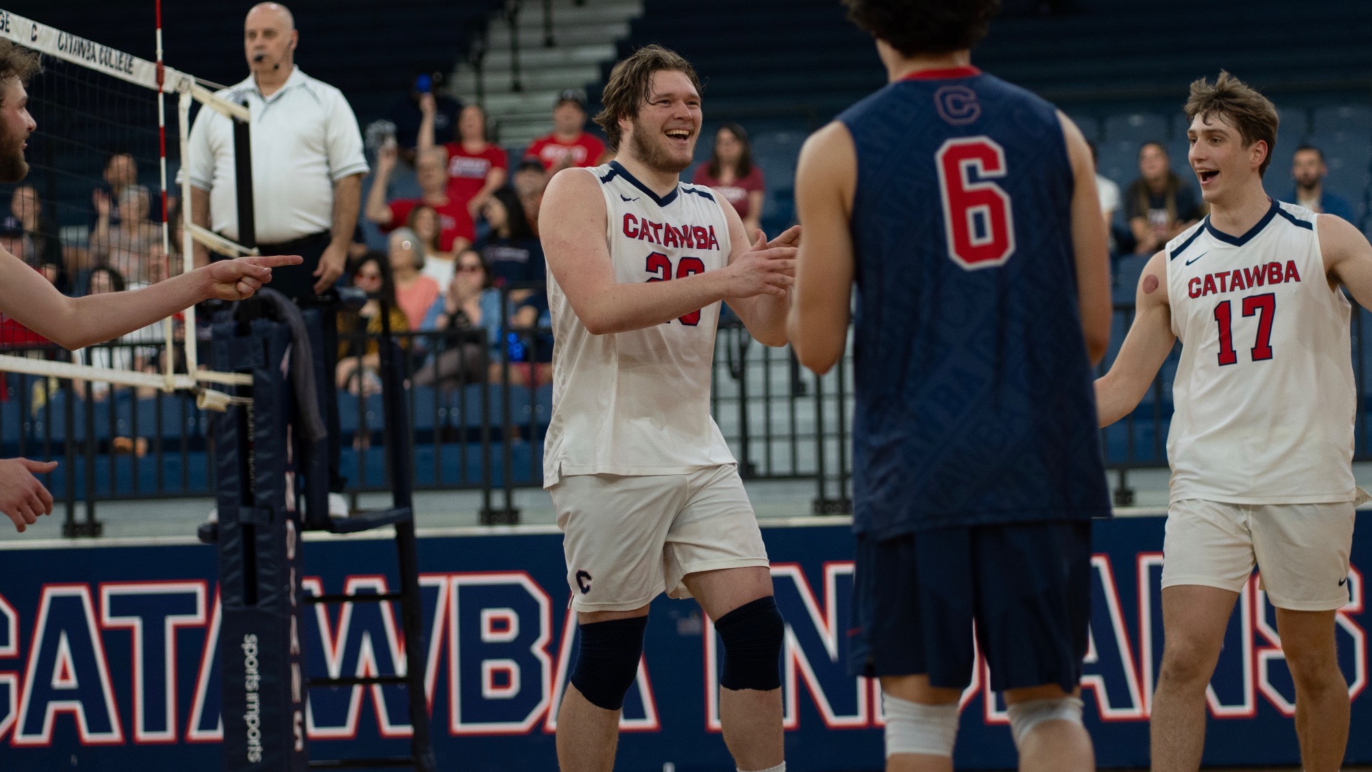 Kristian Smith smiles and claps while celebrating a point
