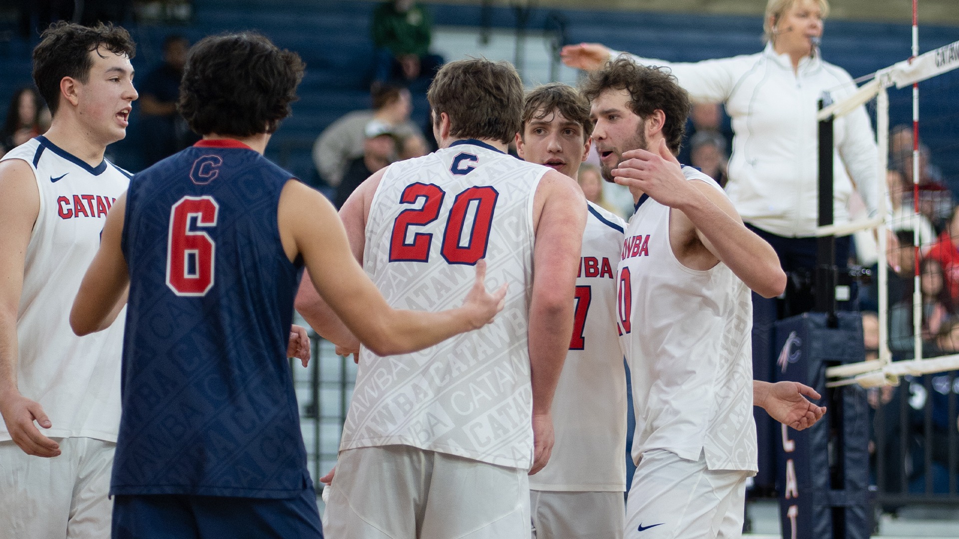 Men's Volleyball huddling after a point