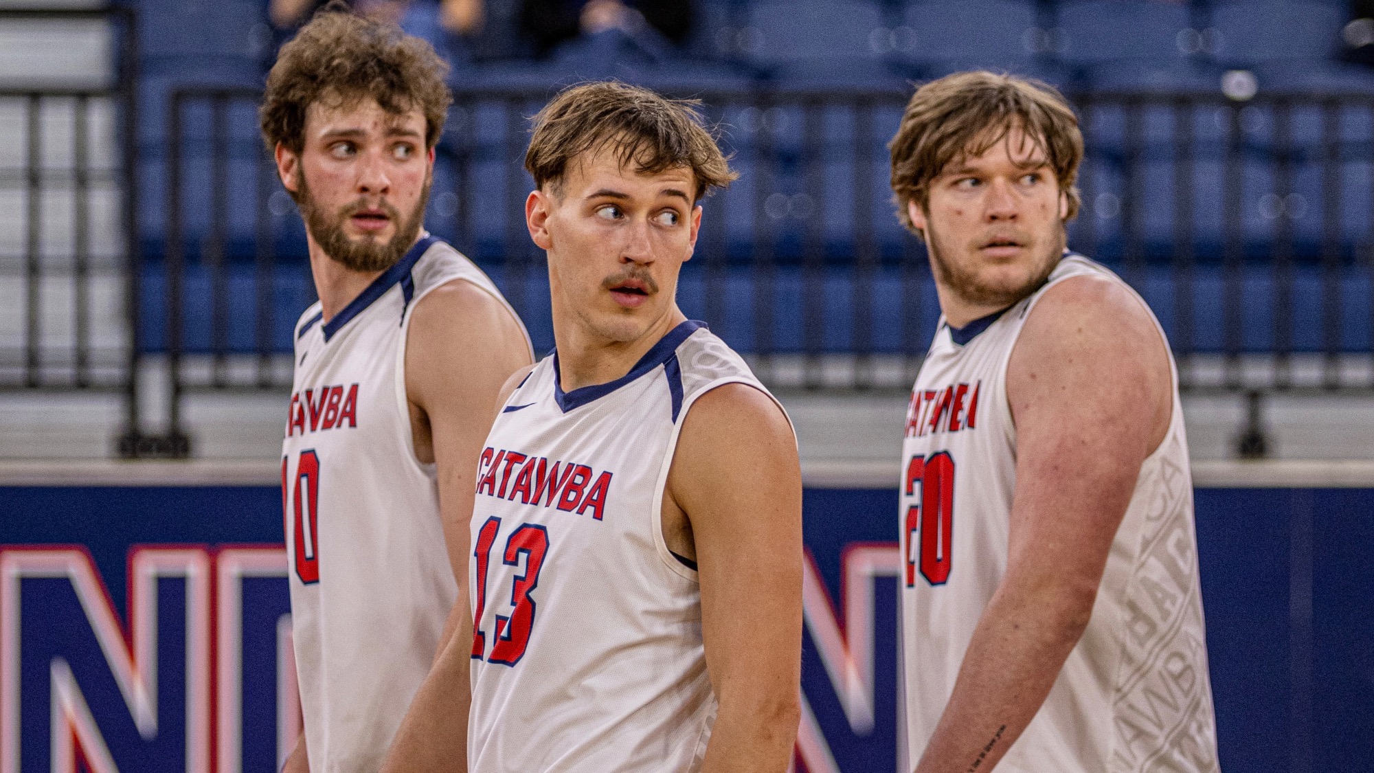 Wyatt Eastin, Justin Arrowood, and Kristian Smith turn their heads to receive instruction against Barton