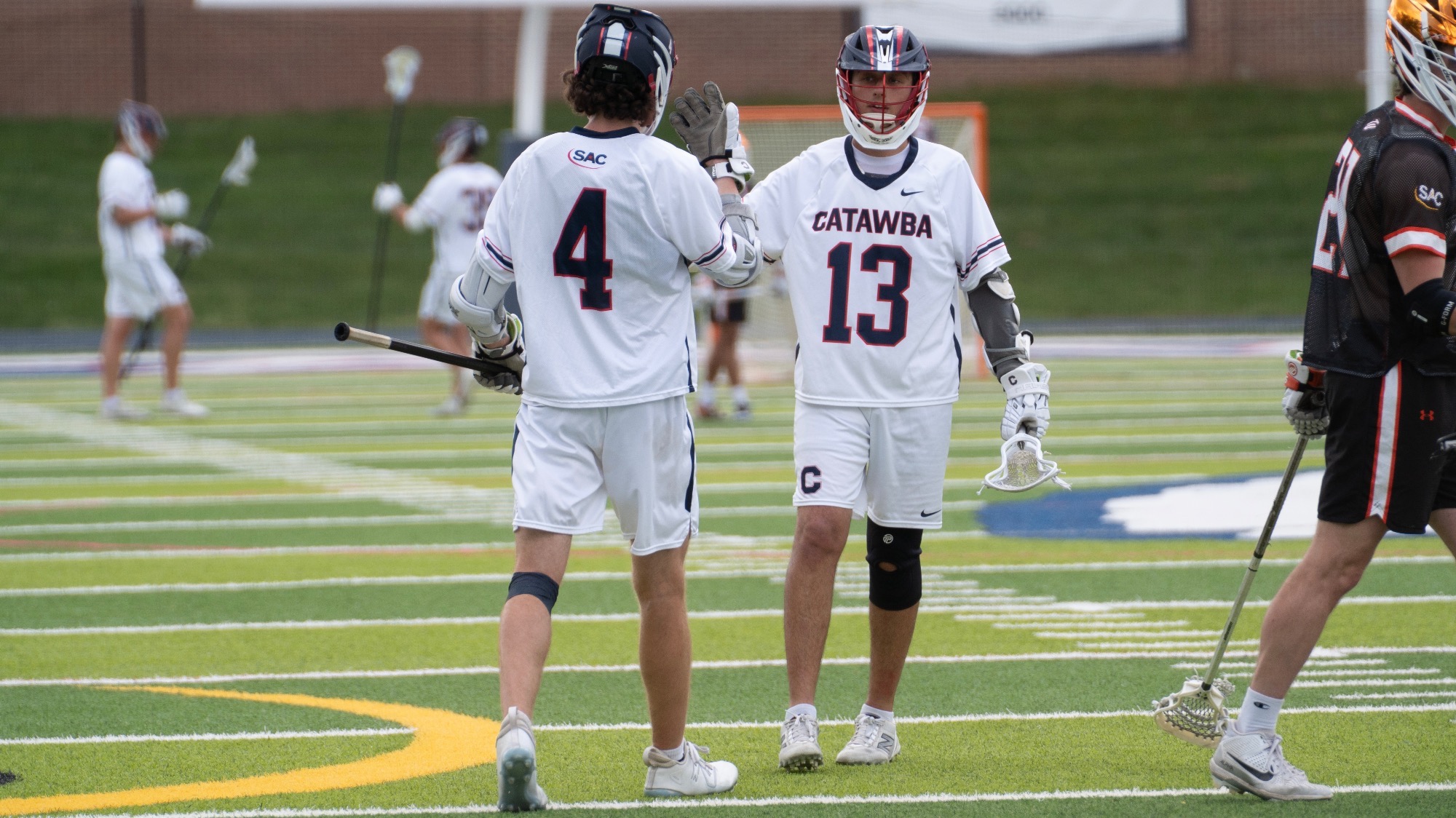 Tanner Stout and Peyton Turner high-five to celebrate a goal against Tusculum