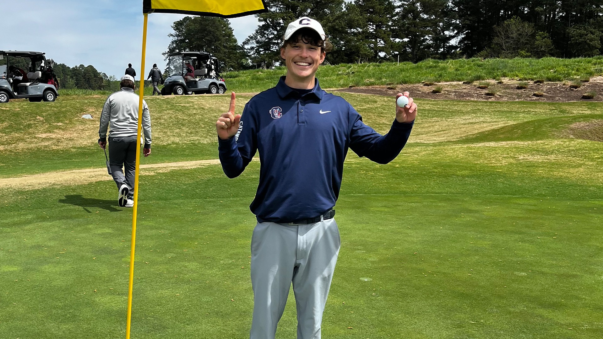 Maxence Bonnet holding his golf ball after hitting a hole-in-one at the Irish Creek Intercollegiate