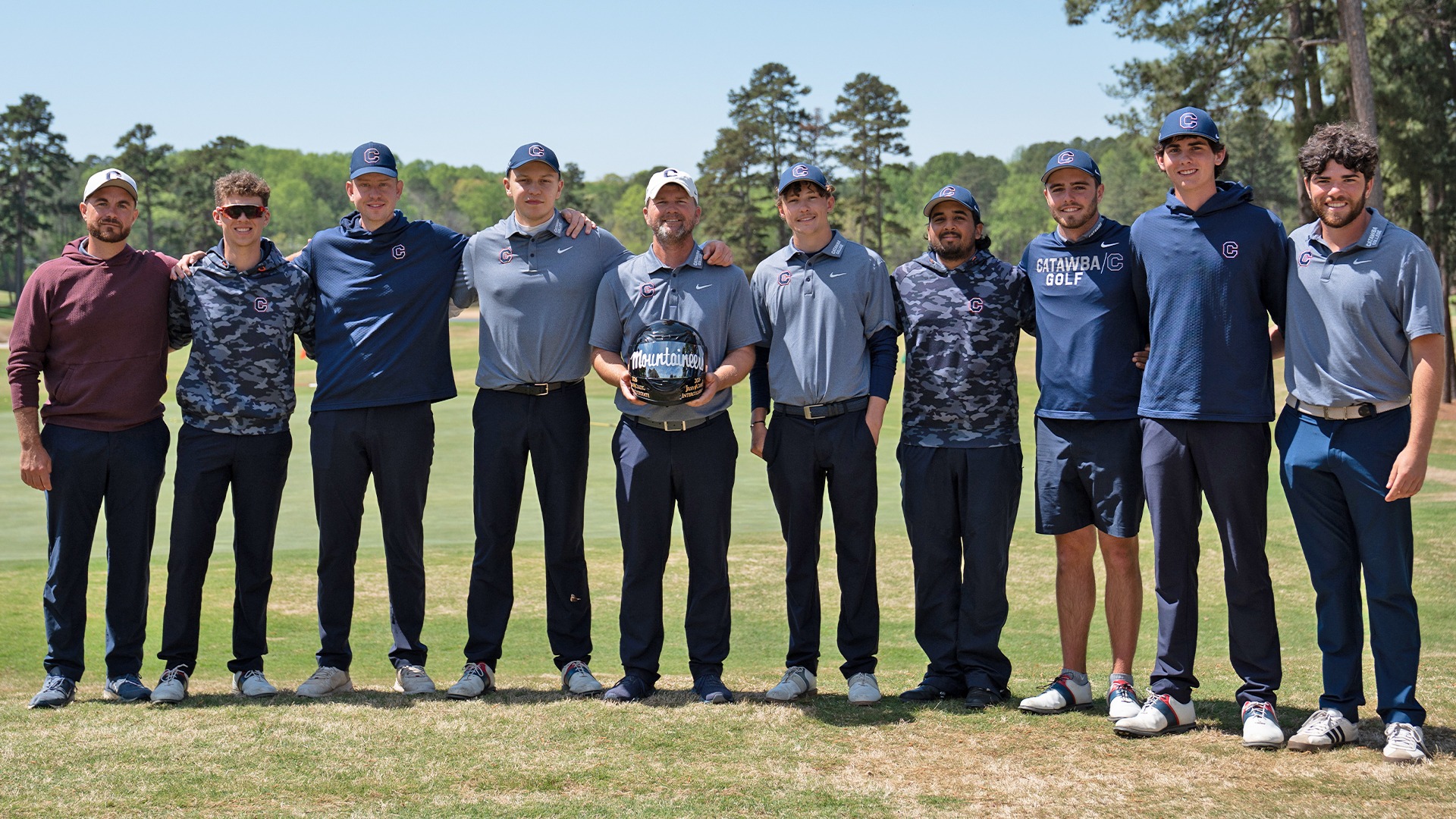 Catawba Men's Golf posing with the Irish Creek Intercollegiate helmet trophy