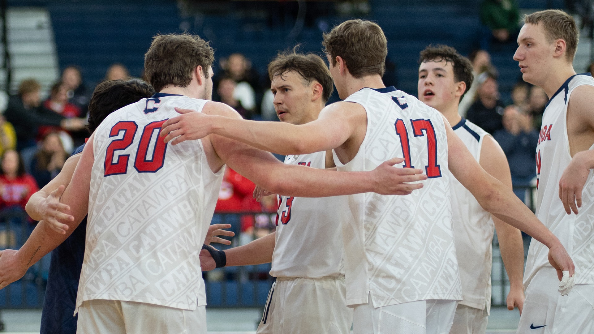 Men's Volleyball huddles after a rally against Lees-McRae
