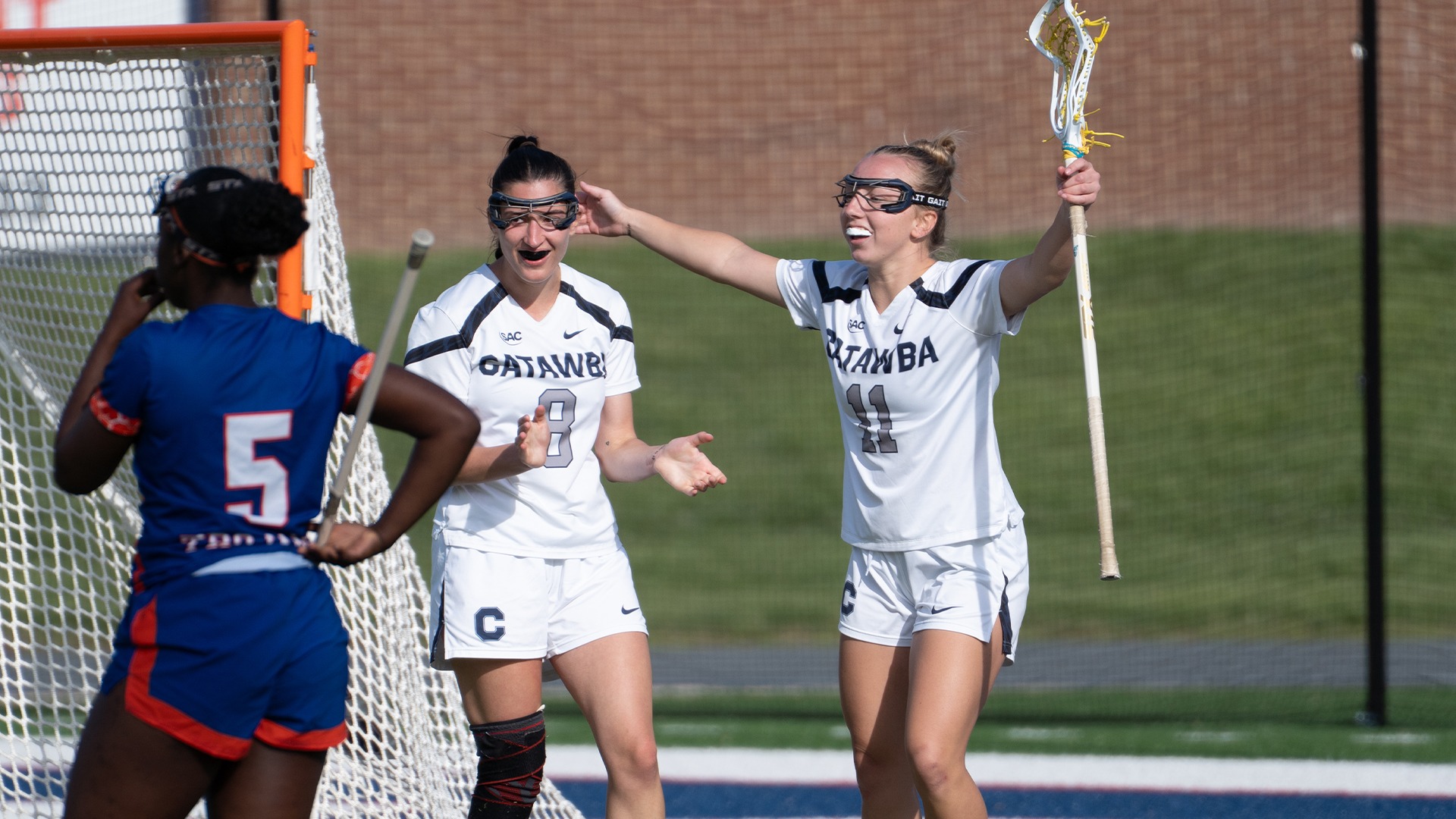 Mary Sorvillo and Abby Shuren clap and throw their hands up after a goal against Virginia State