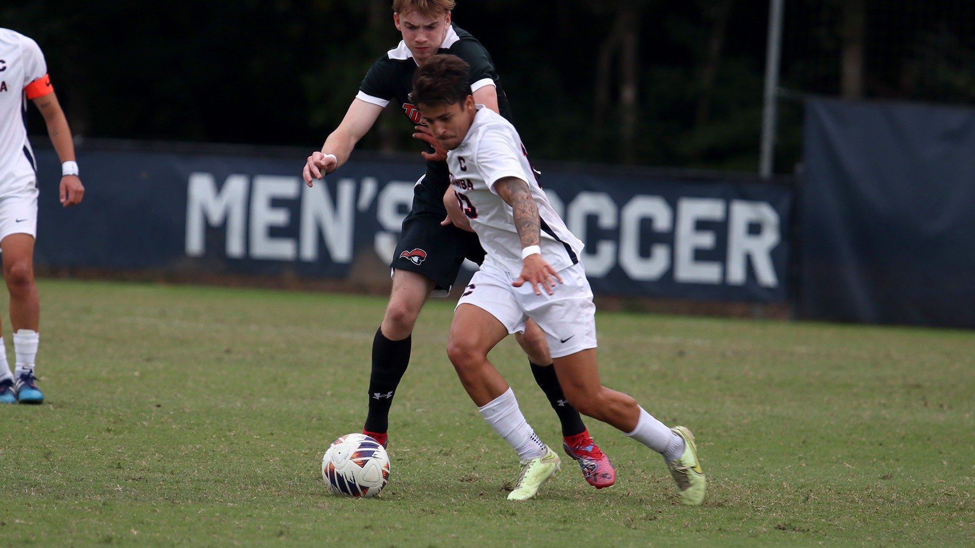 Luis Rodrigues dribbling around a Tusculum defender