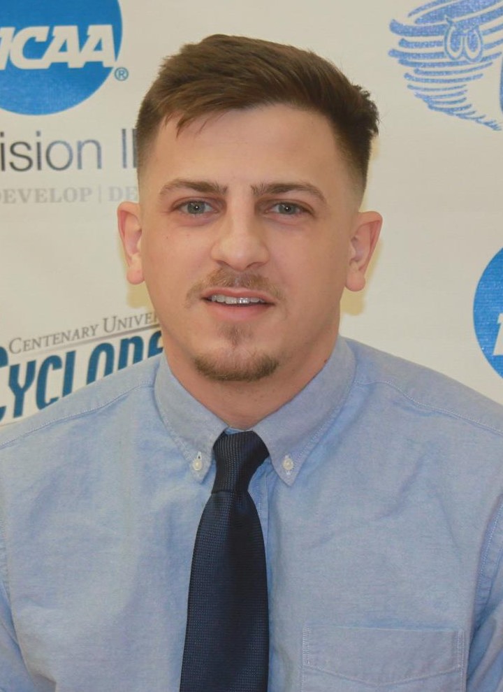 Luke Treamont (head and shoulders mug shot in a blue shirt and tie)